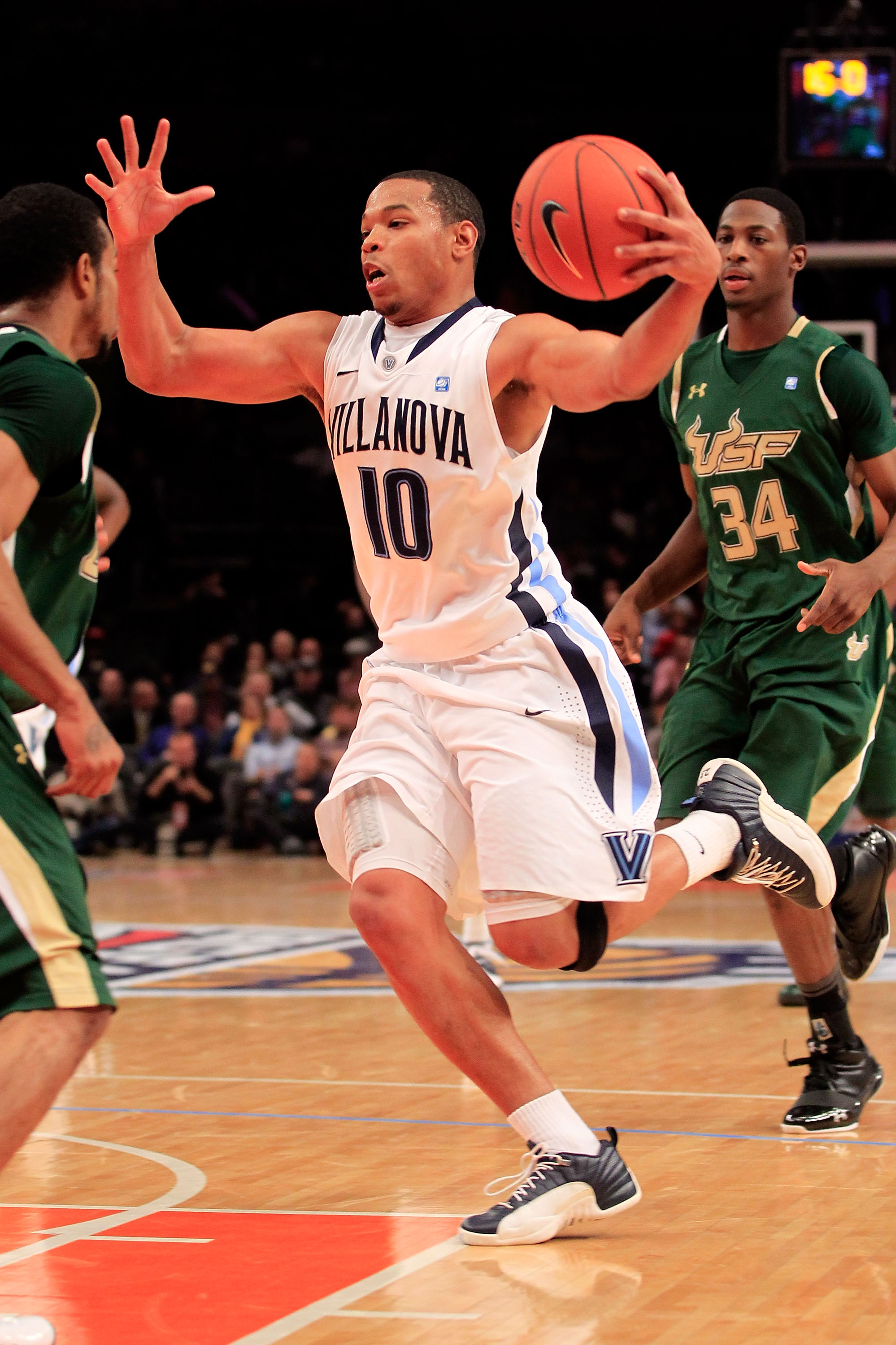 NEW YORK, NY - MARCH 08:  Corey Fisher #10 of the Villanova Wildcats drives with the ball against Anthony Crater #10 of the South Florida Bulls during the first round of the 2011 Big East Men's Basketball Tournament presented by American Eagle Outfitters