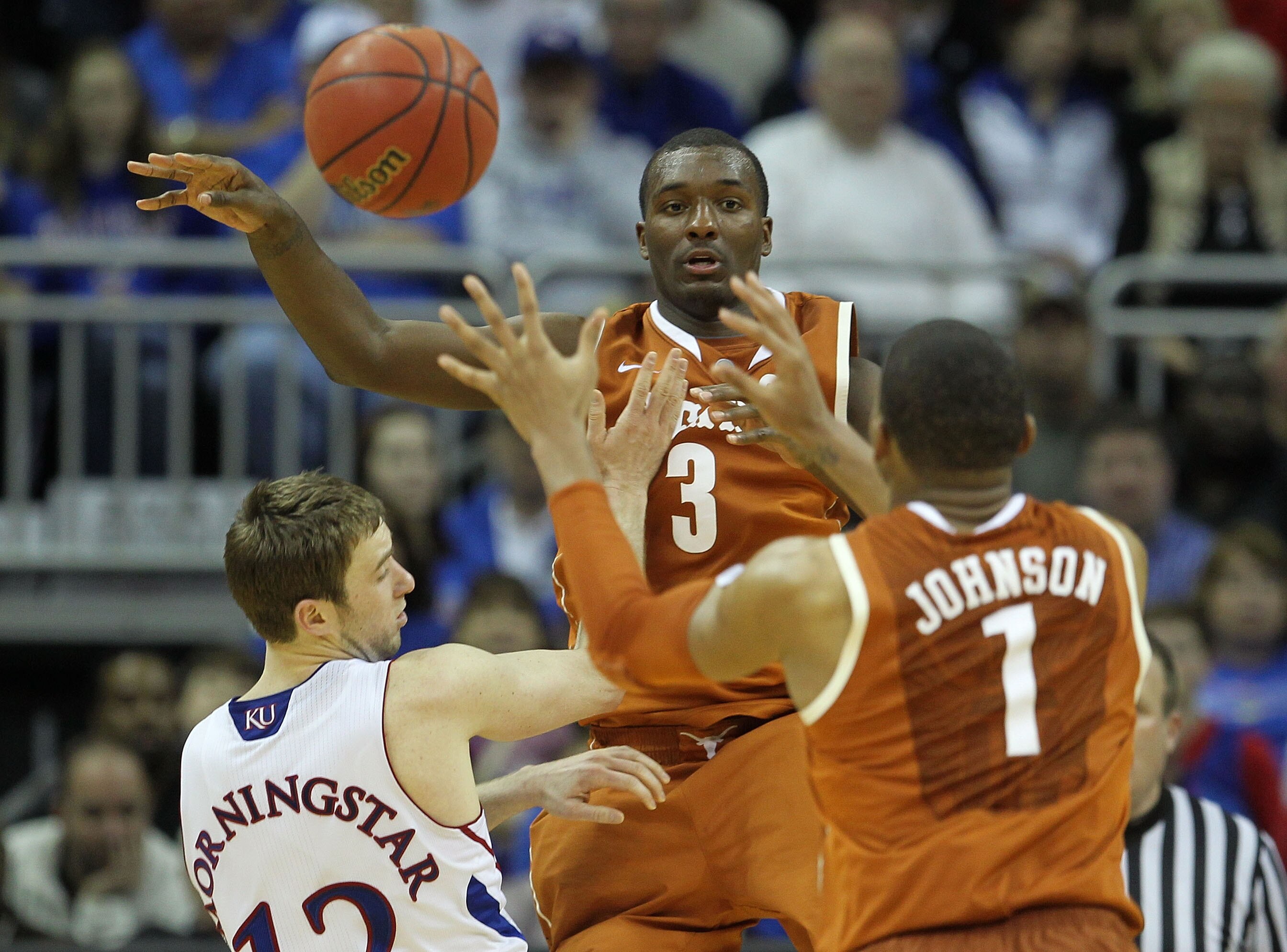 KANSAS CITY, MO - MARCH 12:  Jordan Hamilton #3 of the Texas Longhorns passes the ball to Gary Johnson #1 during the 2011 Phillips 66 Big 12 Men's Basketball Tournament championship game at Sprint Center on March 12, 2011 in Kansas City, Missouri.  (Photo
