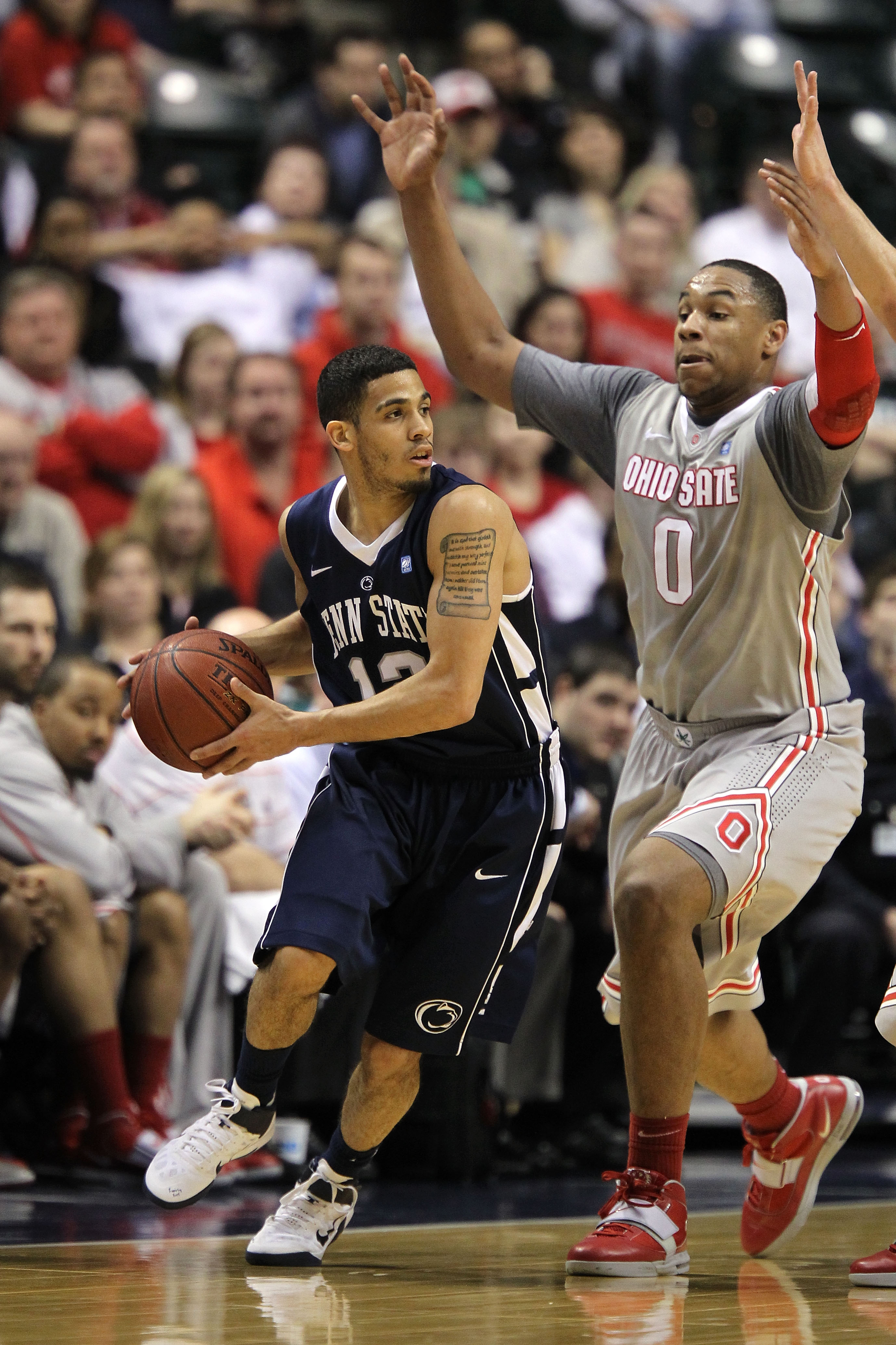 INDIANAPOLIS, IN - MARCH 13:  Talor Battle #12 of the Penn State Nittany Lions looks to pass against Jared Sullinger #0 of the Ohio State Buckeyes during the championship game of the 2011 Big Ten Men's Basketball Tournament at Conseco Fieldhouse on March