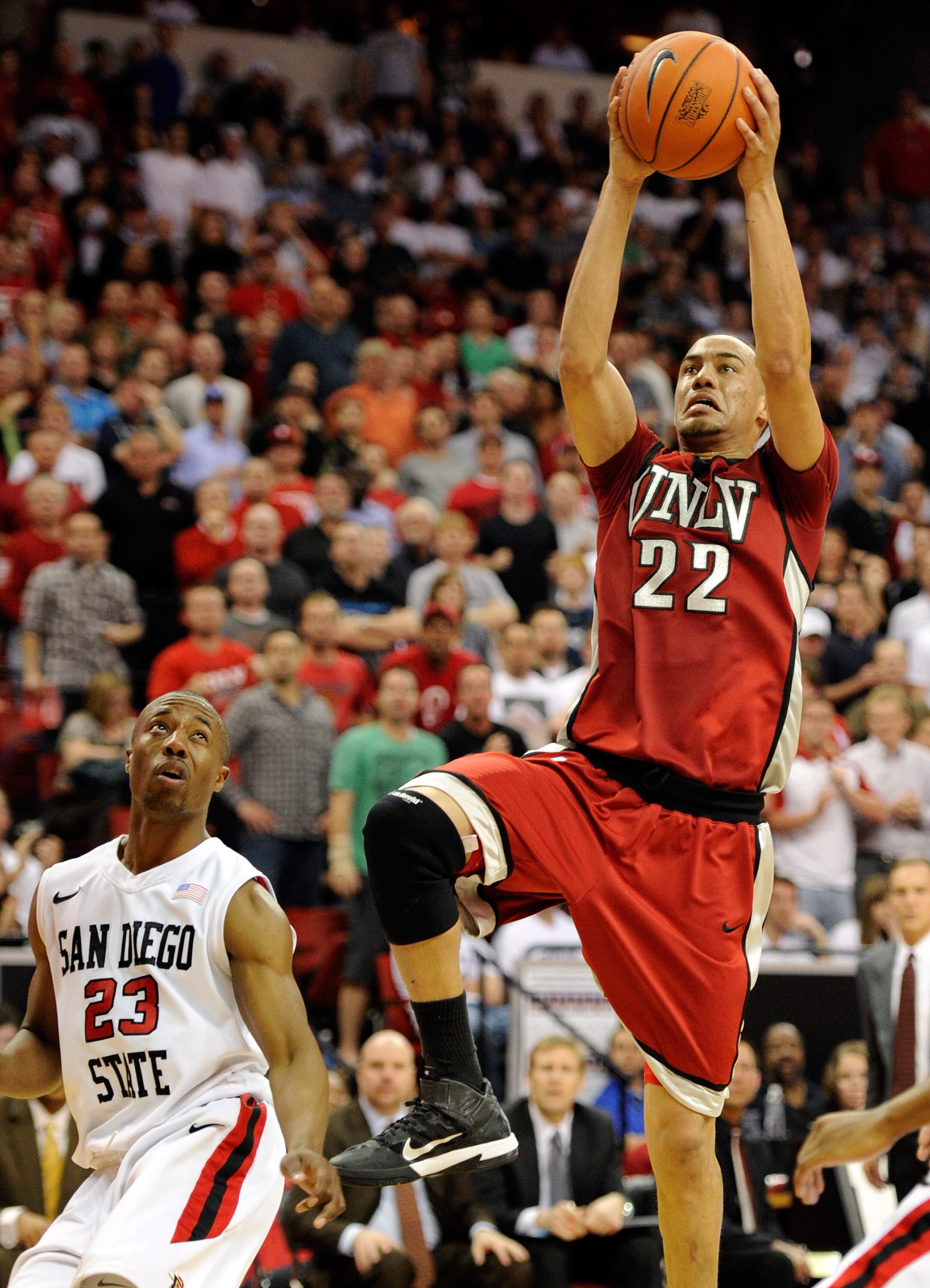 LAS VEGAS, NV - MARCH 11:  Chace Stanback #22 of the UNLV Rebels shoots against D.J.Gay #23 of the San Diego State Aztecs during a semifinal game of the Conoco Mountain West Conference Basketball tournament at the Thomas & Mack Center March 11, 2011 in La