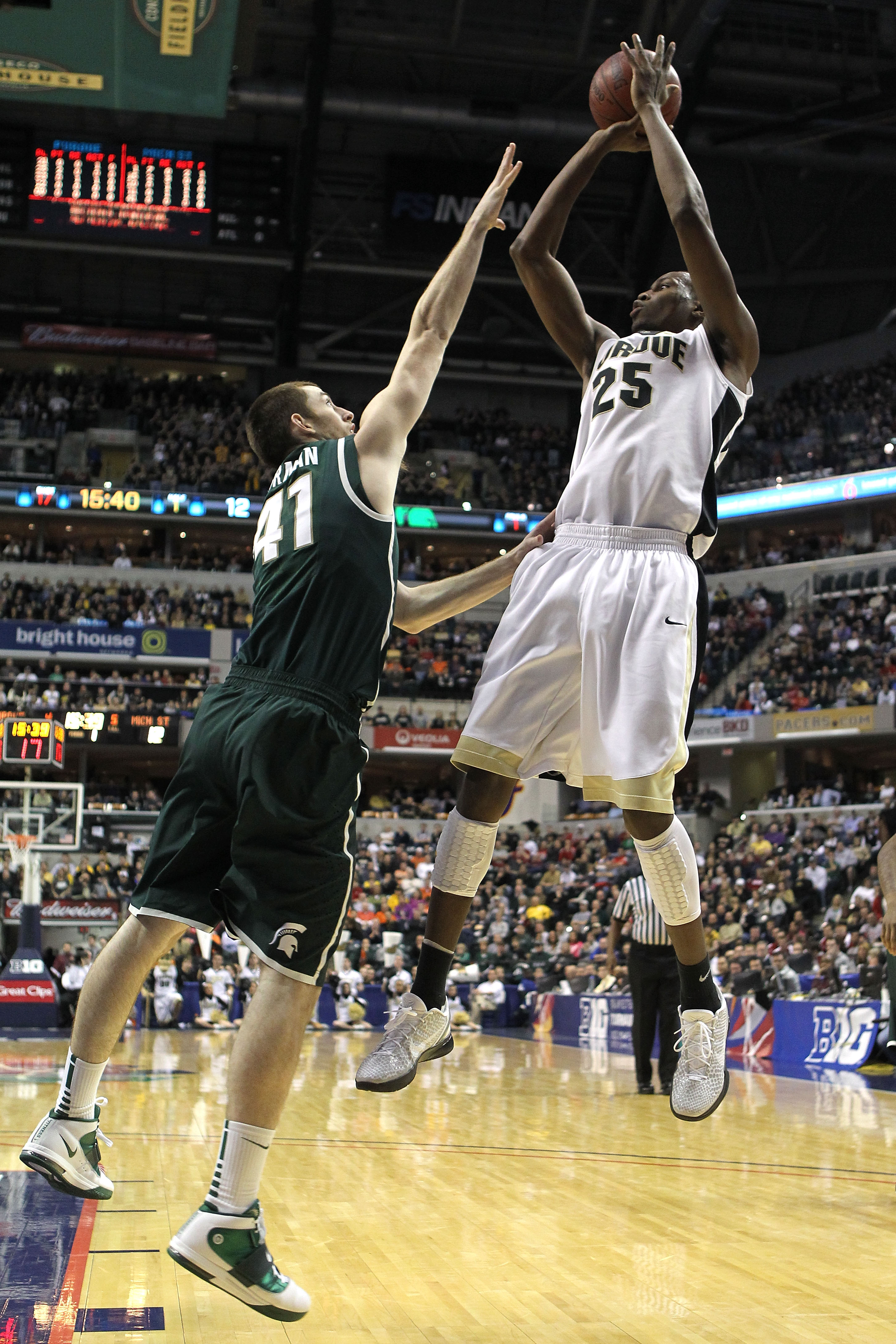 INDIANAPOLIS, IN - MARCH 11:  JaJuan Johnson #25 of the Purdue Boilermakers attempts a shot against Garrick Sherman #41 of the Michigan State Spartans during the quarterfinals of the 2011 Big Ten Men's Basketball Tournament at Conseco Fieldhouse on March