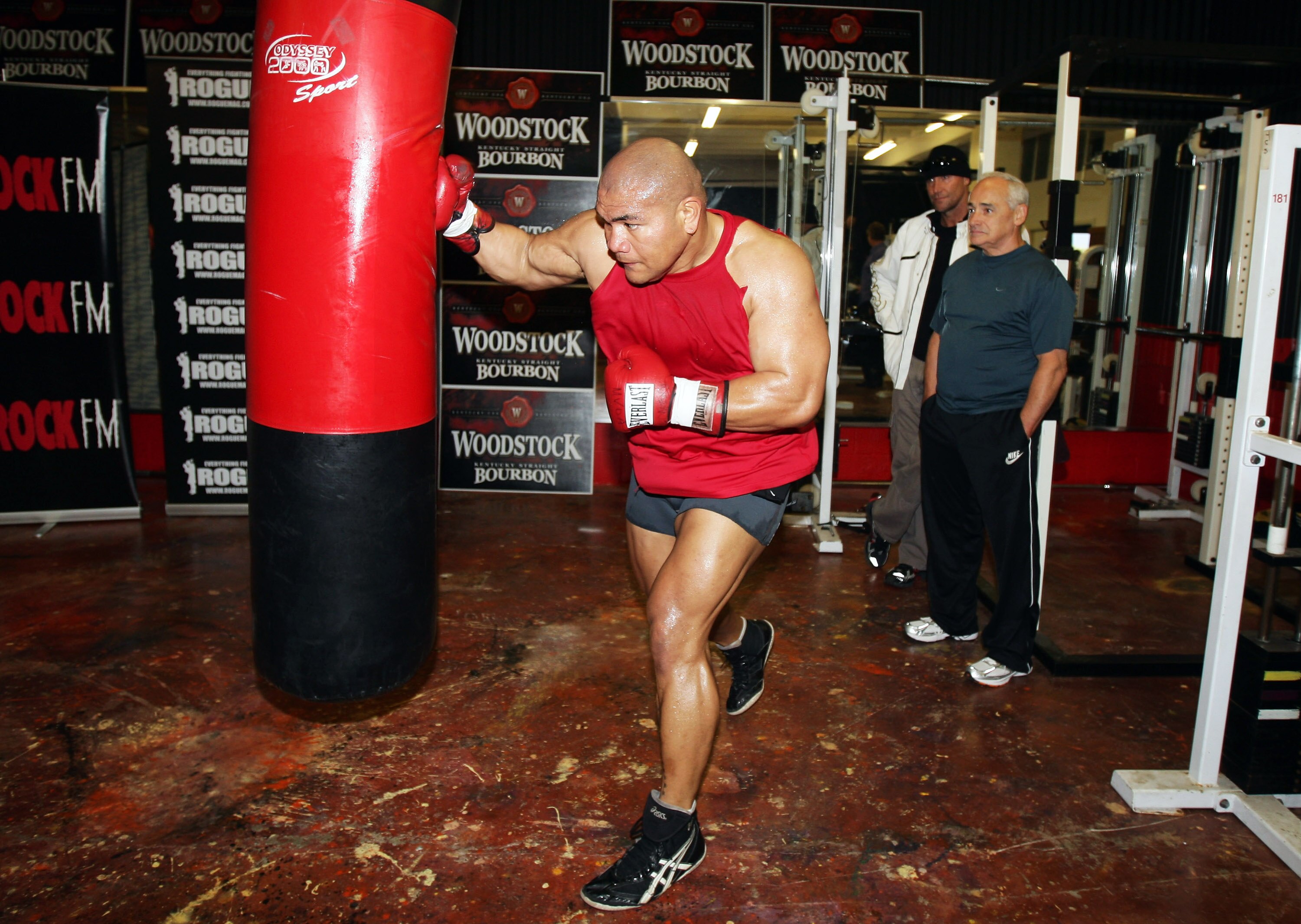 AUCKLAND, NEW ZEALAND - AUGUST 11:  David Tua's trainers Lee Parore and Roger Bloodworth watch him punch the heavy bag during a training session at his gym on August 11, 2009 in Auckland, New Zealand.  (Photo by Sandra Mu/Getty Images)