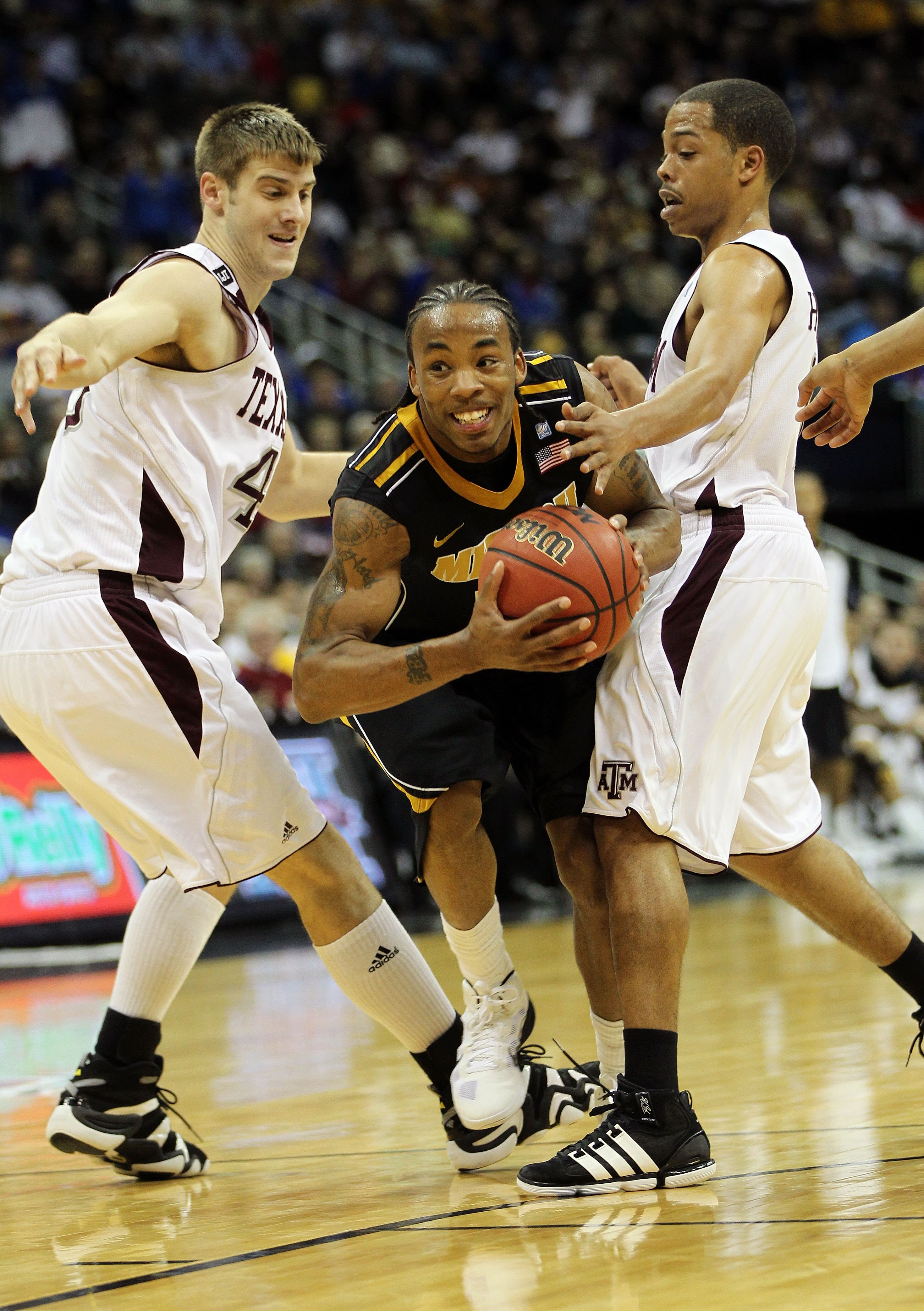 KANSAS CITY, MO - MARCH 10:  Marcus Denmon #12 of the Missouri Tigers drives to the hoop against the Texas A&M Aggies during their quarterfinal game in the 2011 Phillips 66 Big 12 Men's Basketball Tournament at Sprint Center on March 10, 2011 in Kansas Ci