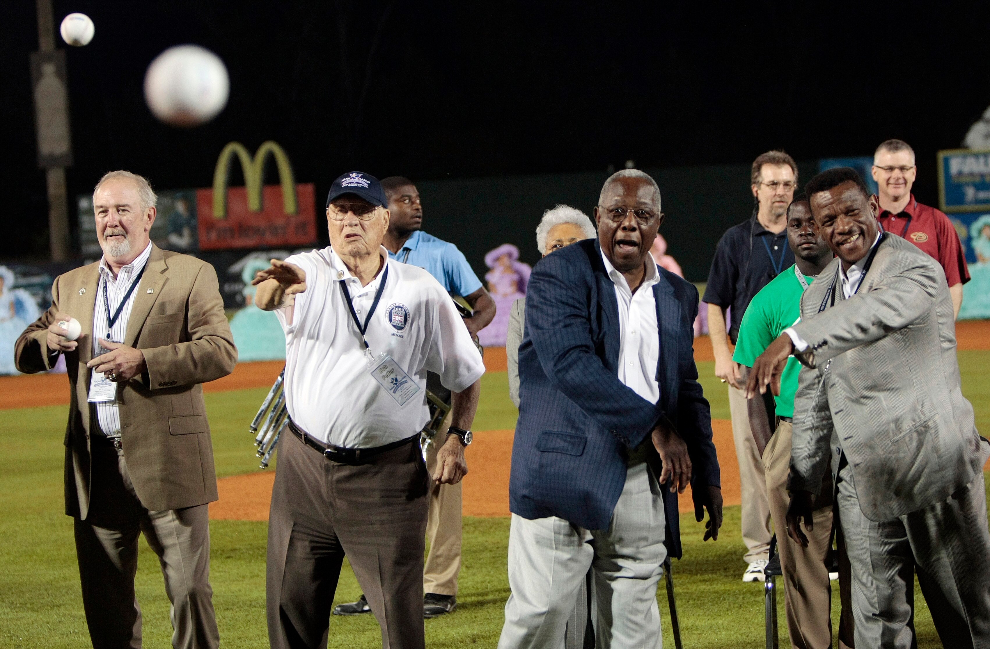 MOBILE, AL - APRIL 14:  Baseball Hall of Famers (L-R) Bruce Sutter, Bob Feller, Hank Aaron and Rickey Henderson throw out the first pitch during pre-game ceremonies following the opening the Hank Aaron Museum at the Hank Aaron Stadium on April 14, 2010 in