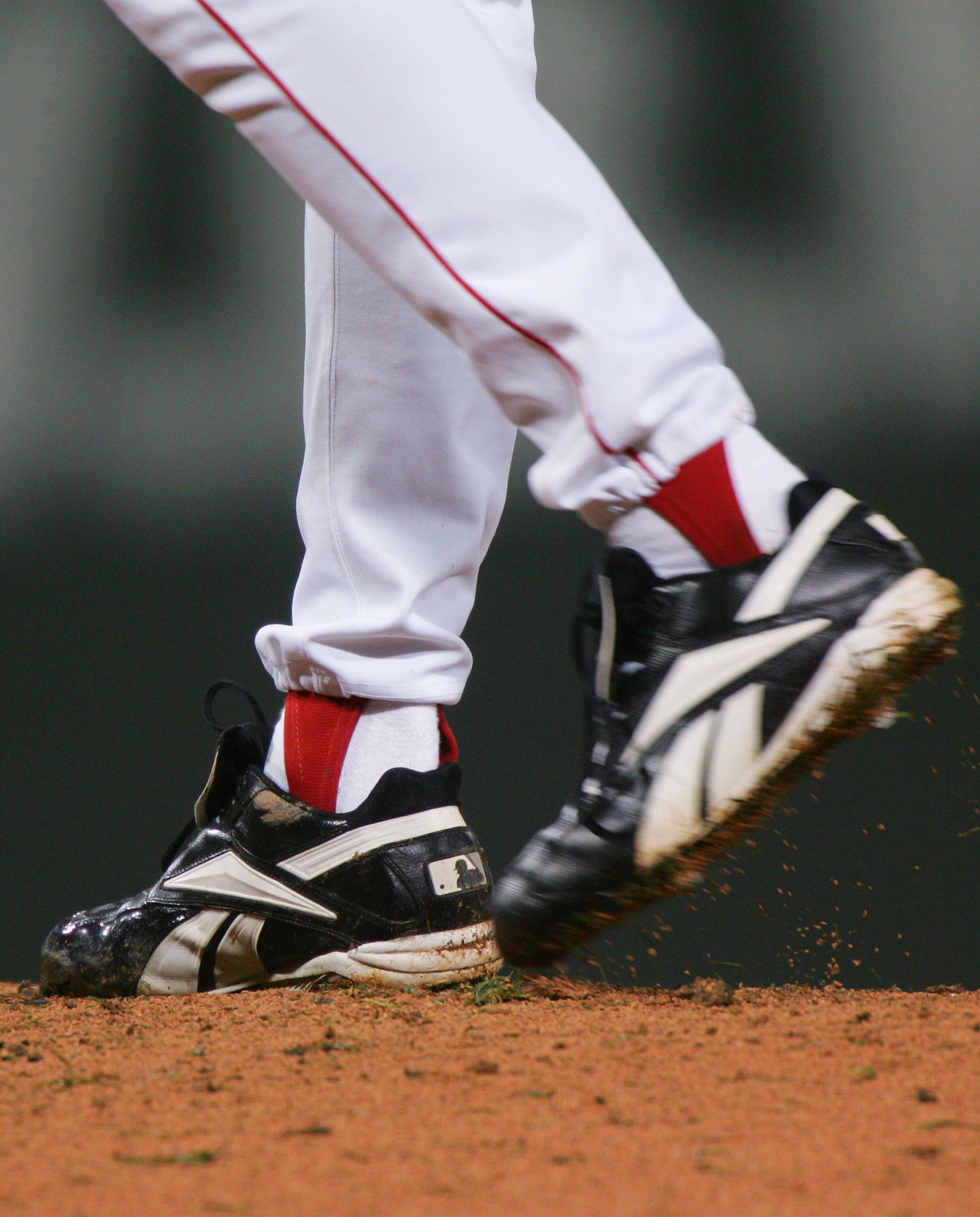 BOSTON - OCTOBER 24:  Curt Schilling #34 of the Boston Red Sox winds up to throw a pitch in the first inning against the St. Louis Cardinals during game two of the World Series on October 24, 2004 at Fenway Park in Boston, Massachusetts. (Photo by Jed Jac