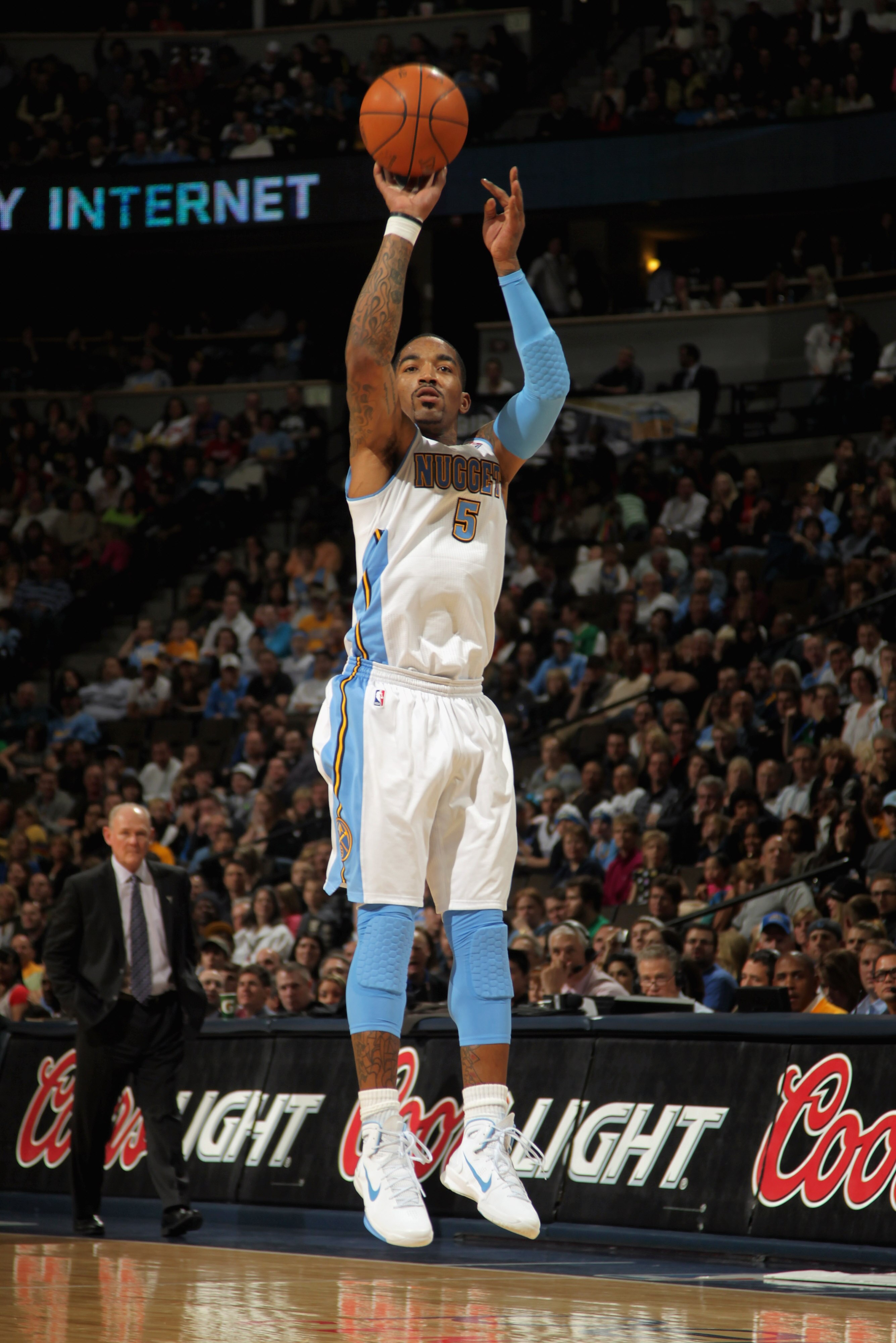 DENVER, CO - MARCH 12:  J.R. Smith #5 of the Denver Nuggets takes a three point shot as he had a game high 31 points agianst the Detroit Pistons as he goes to the basket at the Pepsi Center on March 12, 2011 in Denver, Colorado. The Nuggets defeated the P
