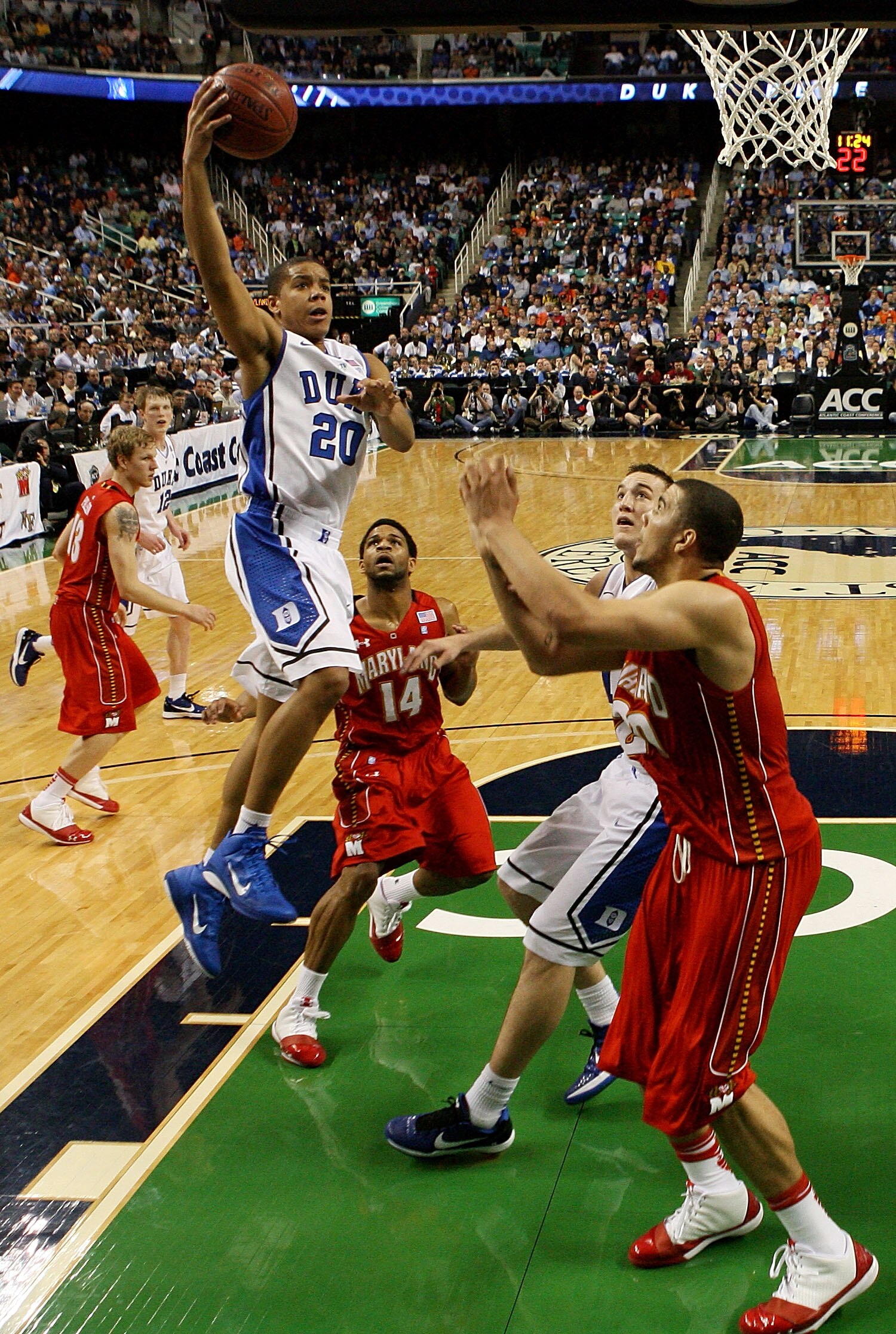 GREENSBORO, NC - MARCH 11:  Andre Dawkins #20 of the Duke Blue Devils shoots against Jordan Williams #20 and Sean Mosley #14 of the Maryland Terrapins during the second half in the quarterfinals of the 2011 ACC men's basketball tournament at the Greensbor