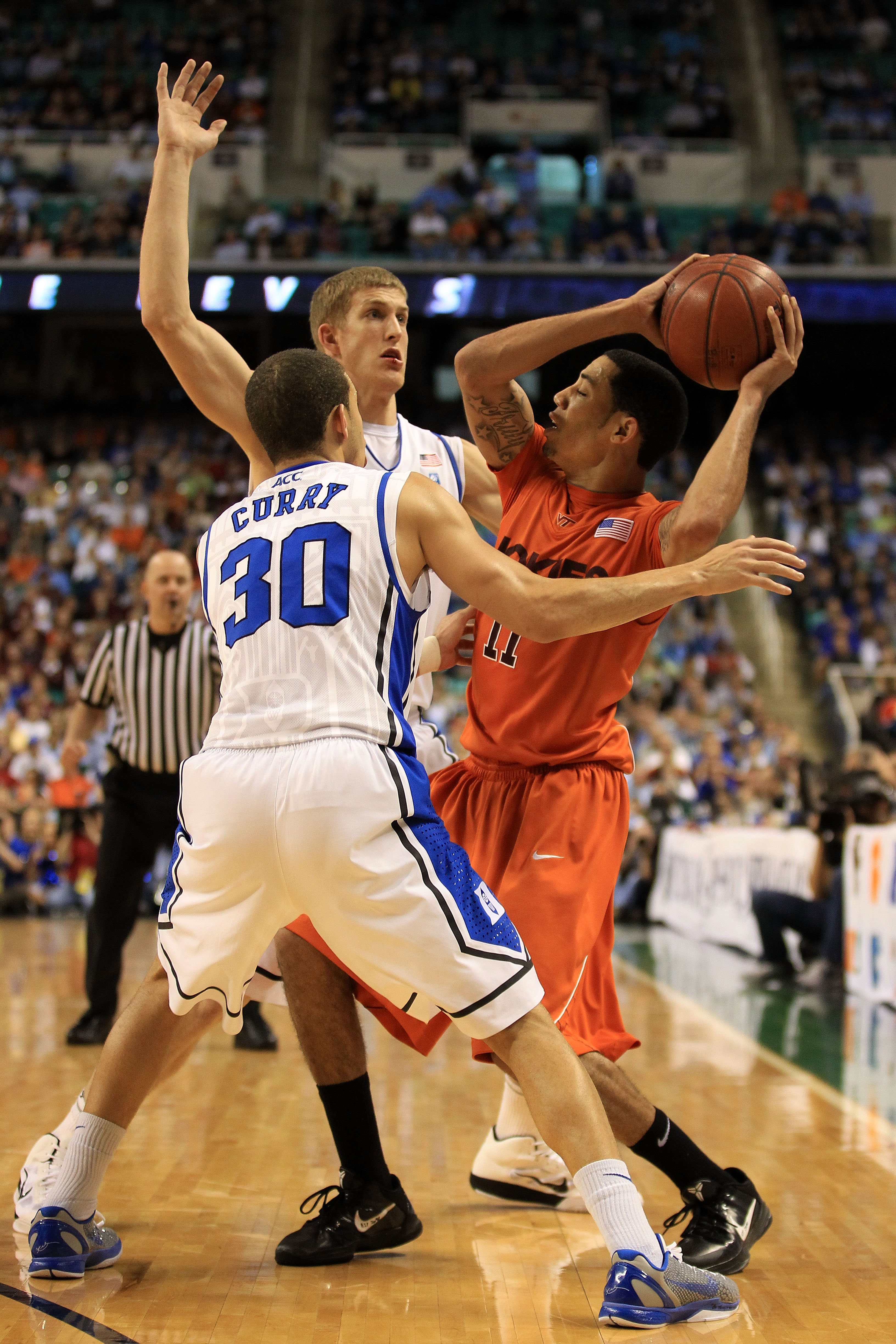 GREENSBORO, NC - MARCH 12:  Erick Green #11 of the Virginia Tech Hokies looks to pass against Seth Curry #30 and Mason Plumlee #5 of the Duke Blue Devils during the second half in the semifinals of the 2011 ACC men's basketball tournament at the Greensbor