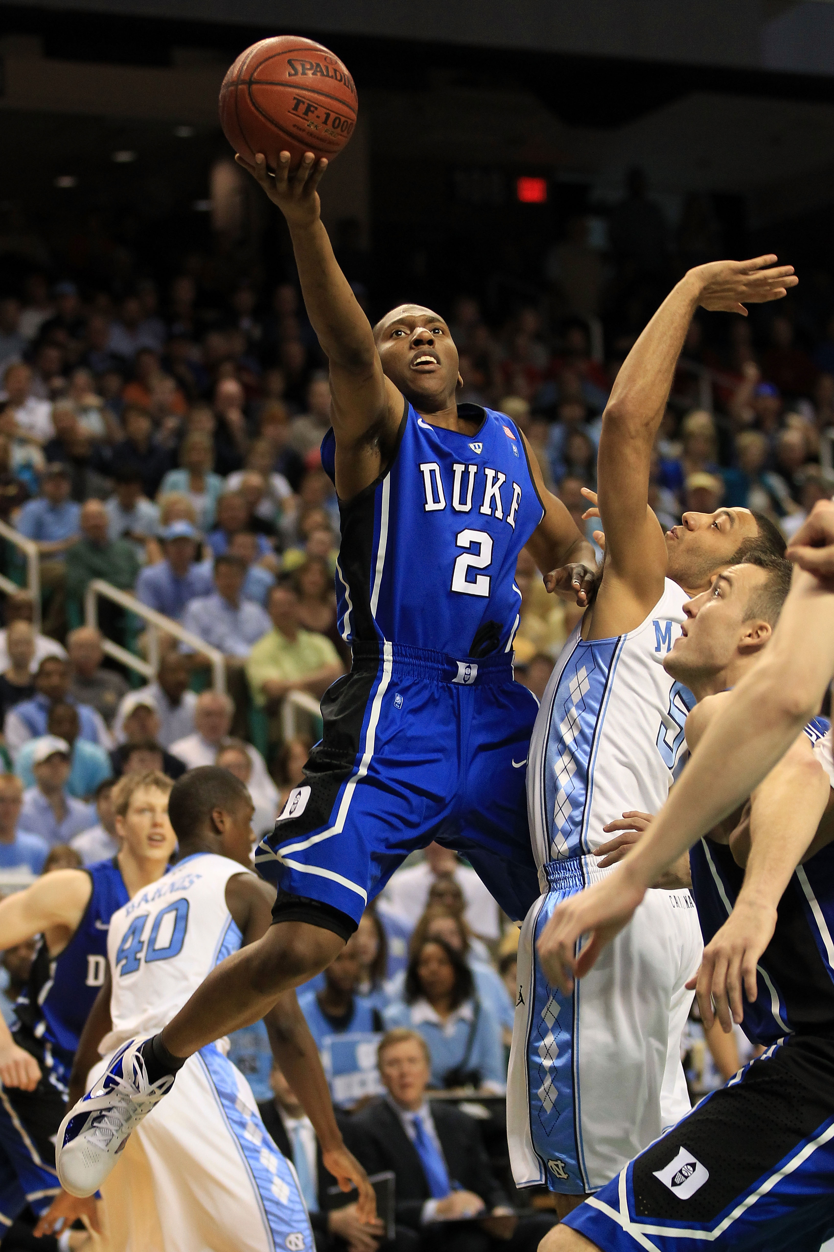 GREENSBORO, NC - MARCH 13:  Nolan Smith #2 of the Duke Blue Devils shoots against Kendall Marshall #5 of the North Carolina Tar Heels during the first half in the championship game of the 2011 ACC men's basketball tournament at the Greensboro Coliseum on