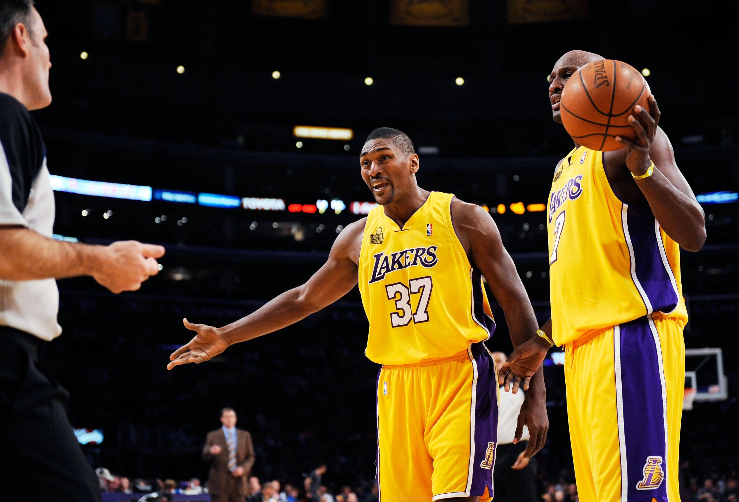 LOS ANGELES, CA - OCTOBER 30: Ron Artest #37 of the Los Angeles Lakers argues with referee Monty McCutchen (L) before getting a technical foul as teammate Lamar Odom #7 looks on during the third quarter of the basketball game against the Dallas Mavericks