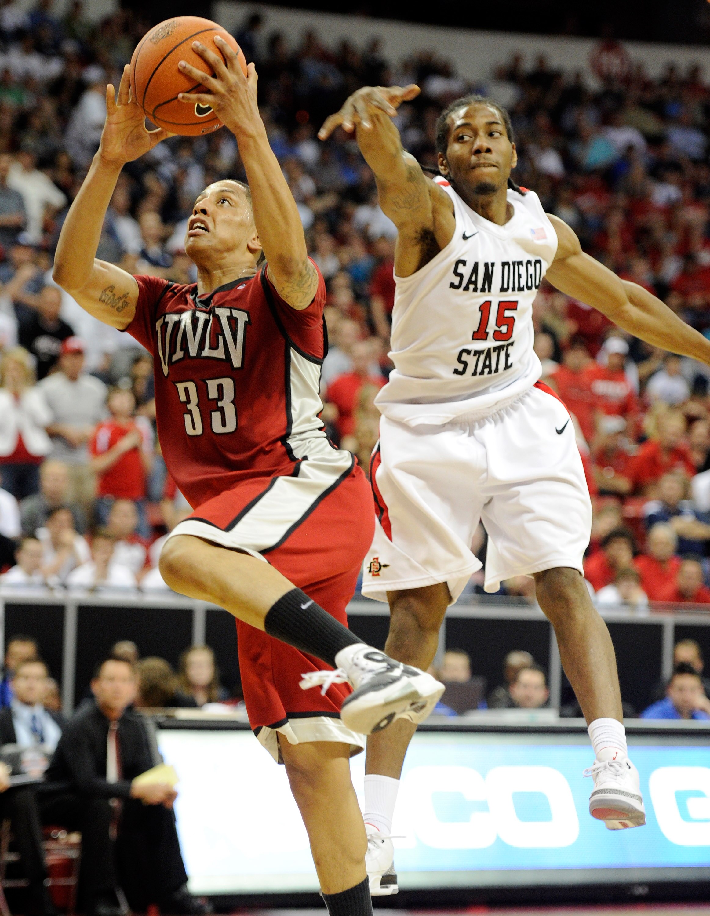 LAS VEGAS, NV - MARCH 11:  Tre'Von Willis #33 of the UNLV Rebels drives to the basket in front of Kawhi Leonard #15 of the San Diego State Aztecs during a semifinal game of the Conoco Mountain West Conference Basketball tournament at the Thomas & Mack Cen
