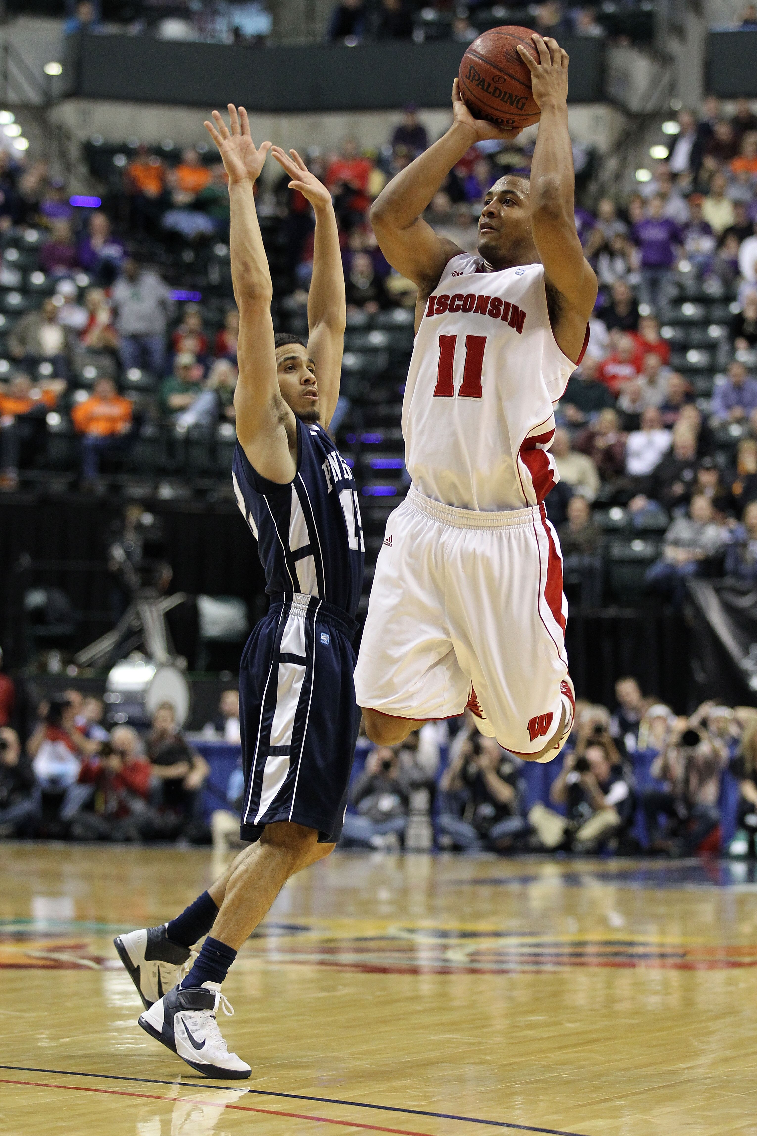 INDIANAPOLIS, IN - MARCH 11:  Jordan Taylor #11 of the Wisconsin Badgers attempts a shot against Talor Battle #12 of the Penn State Nittany Lions during the quarterfinals of the 2011 Big Ten Men's Basketball Tournament at Conseco Fieldhouse on March 11, 2