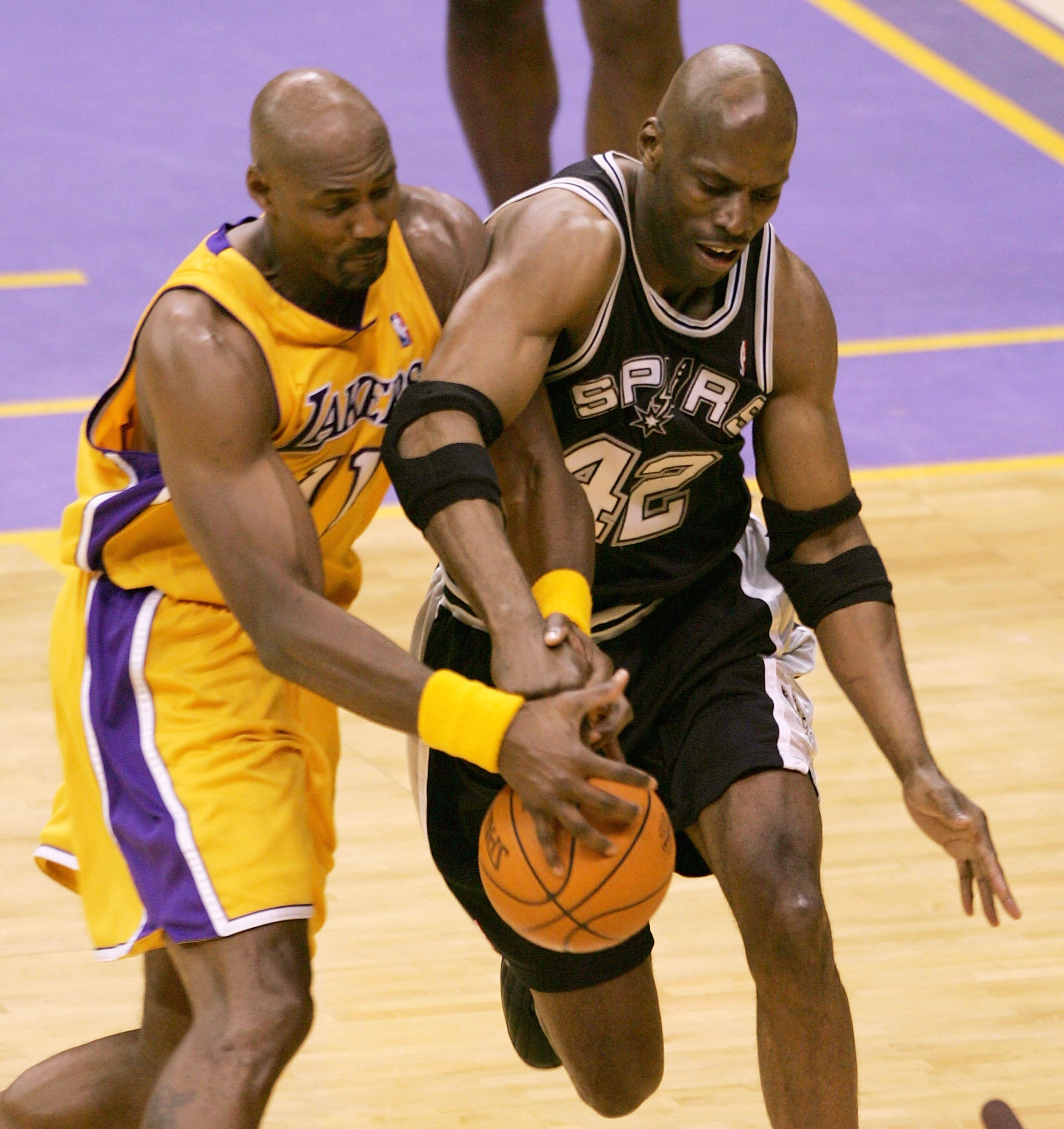 LOS ANGELES - MAY 15:  Karl Malone #11 of the Los Angeles Lakers and Kevin Willis #42 of the San Antonio Spurs during Game six of the Western Conference Semifinals during the 2004 NBA Playoffs at Staples Center on May 15, 2004 in Los Angeles, California.