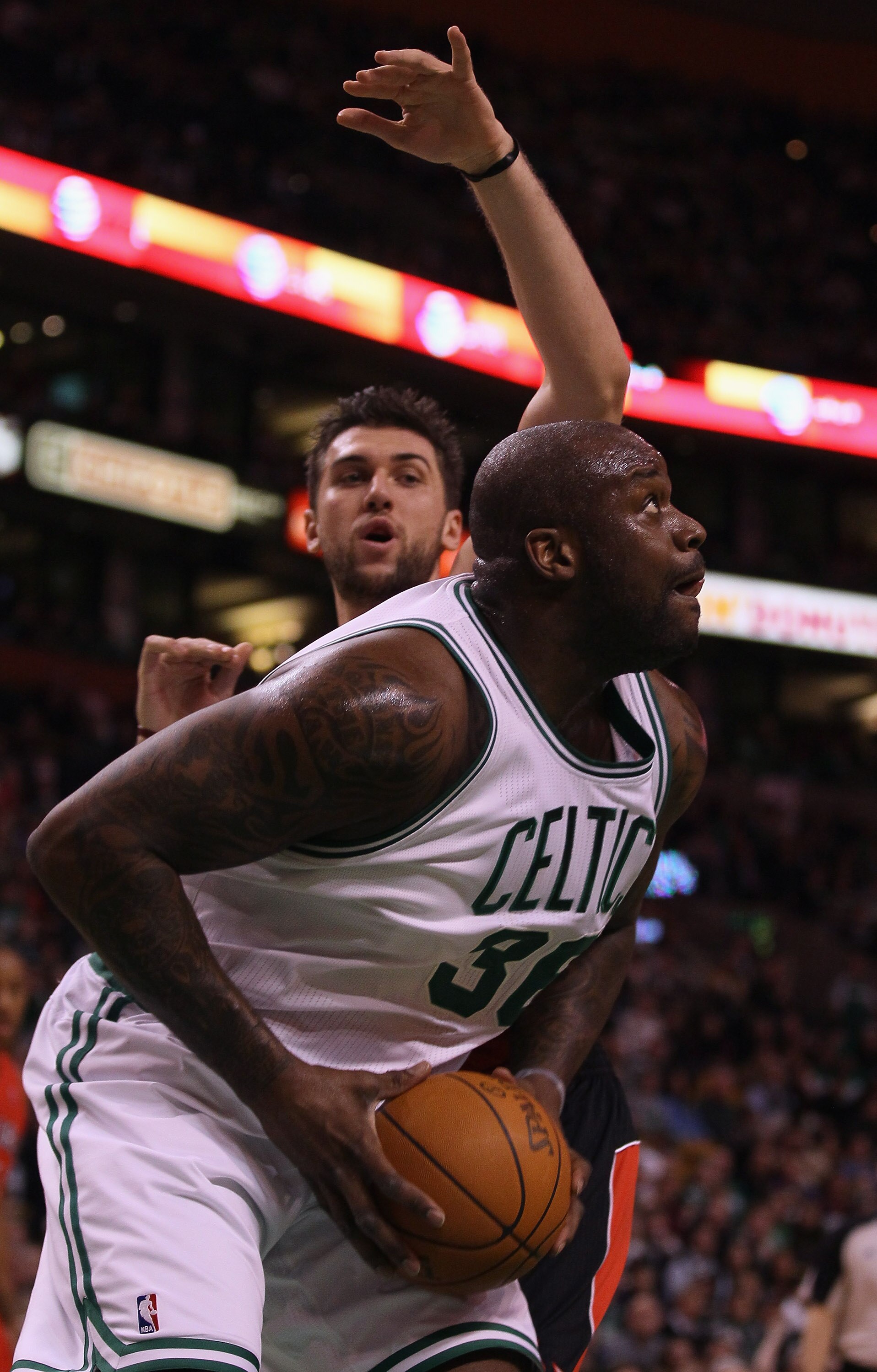 BOSTON, MA - JANUARY 07:  Shaquille O'Neal #36 of the Boston Celtics heads for the basket as Andrea Bargnani #7 of the Toronto Raptors defends on January 7, 2011 at the TD Garden in Boston, Massachusetts. NOTE TO USER: User expressly acknowledges and agre