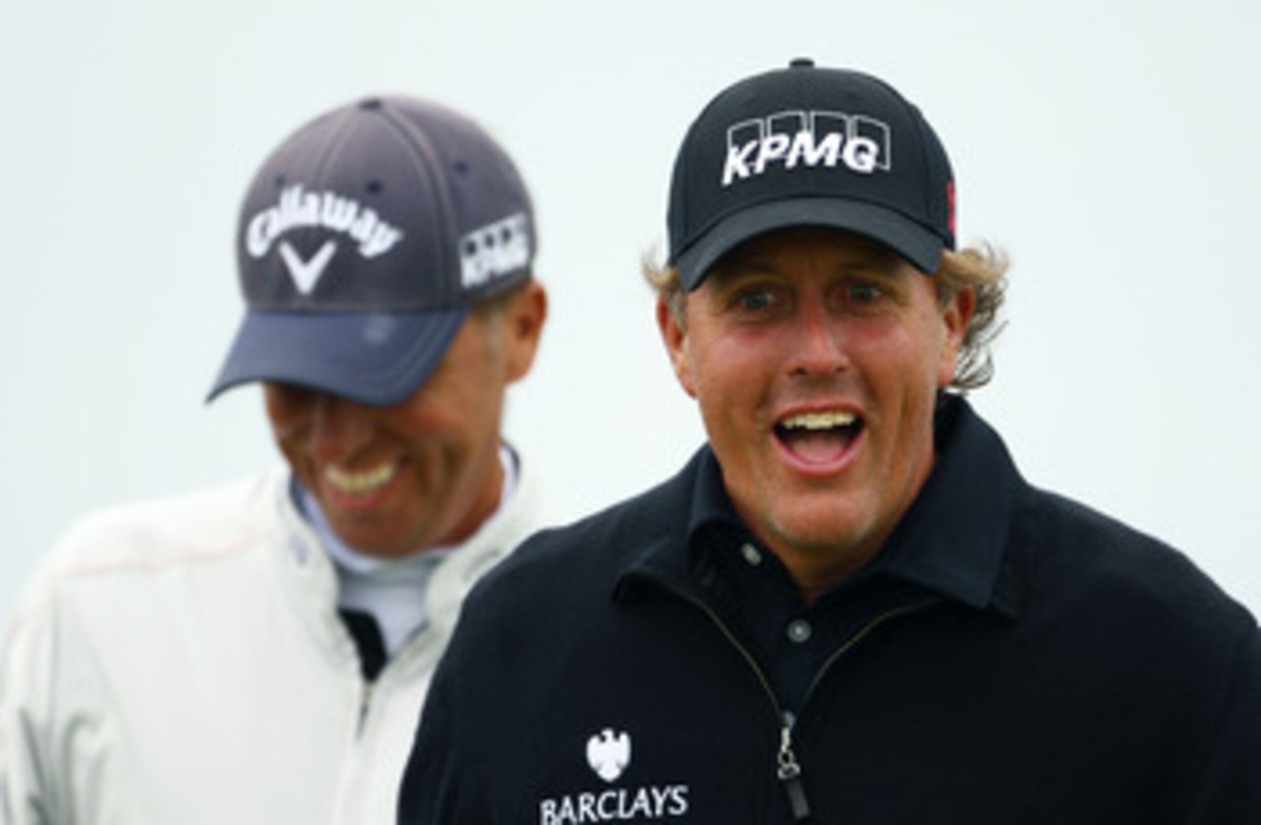 SANDWICH, ENGLAND - JULY 13:  Phil Mickelson (R) of the USA enjoys a joke during the final practice round during The Open Championship at Royal St. George's on July 13, 2011 in Sandwich, England. The 140th Open begins on July 14, 2011..  (Photo by Richard