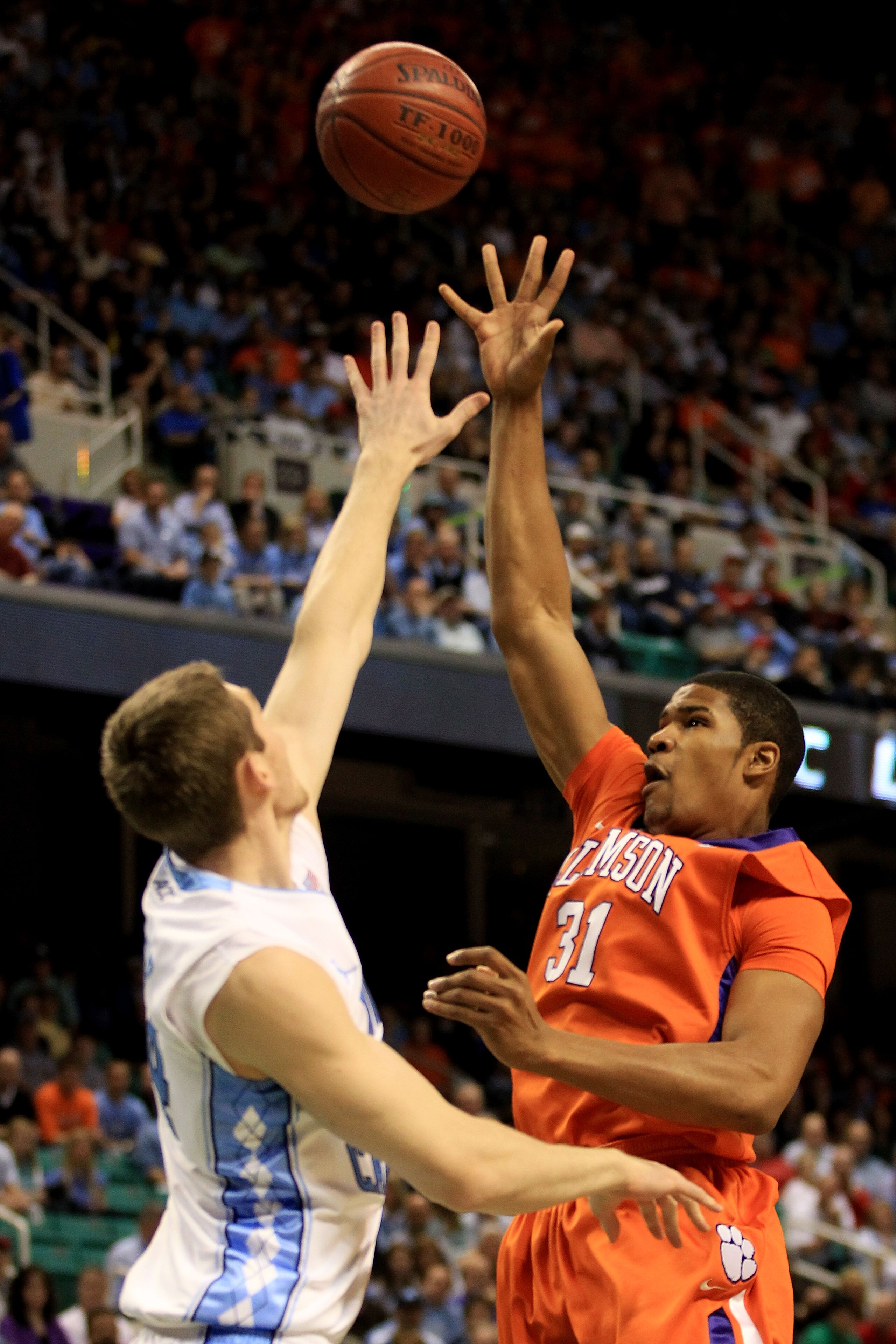 GREENSBORO, NC - MARCH 12:  Devin Booker #31 of the Clemson Tigers shoots against Tyler Zeller #44 of the North Carolina Tar Heels in the semifinals of the 2011 ACC men's basketball tournament at the Greensboro Coliseum on March 12, 2011 in Greensboro, No