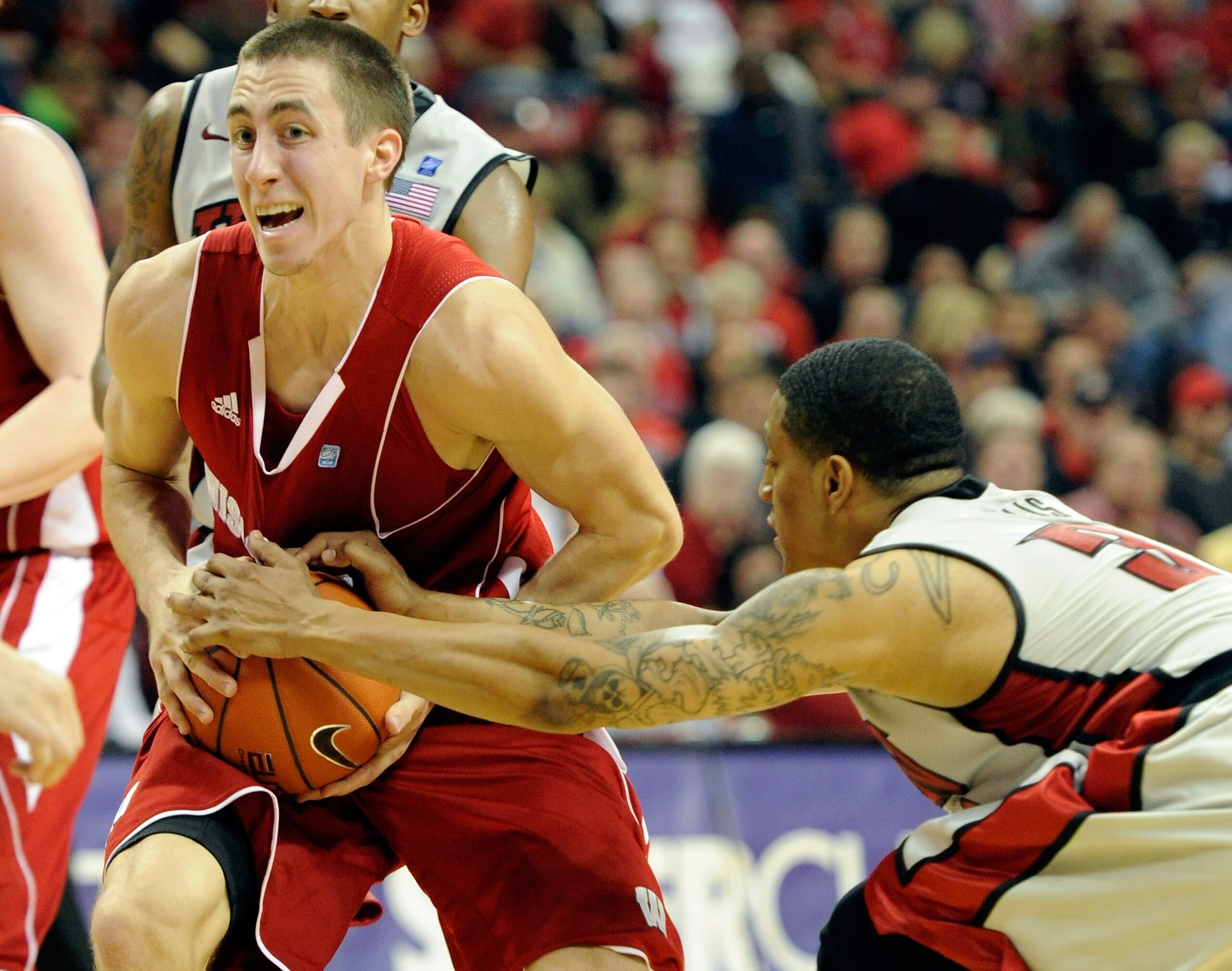 LAS VEGAS - NOVEMBER 20:  Tre'Von Willis #33 of the UNLV Rebels tries to steal the ball from Josh Gasser #21 of the Wisconsin Badgers during their game at the Thomas & Mack Center November 20, 2010 in Las Vegas, Nevada. UNLV won 68-65.  (Photo by Ethan Mi