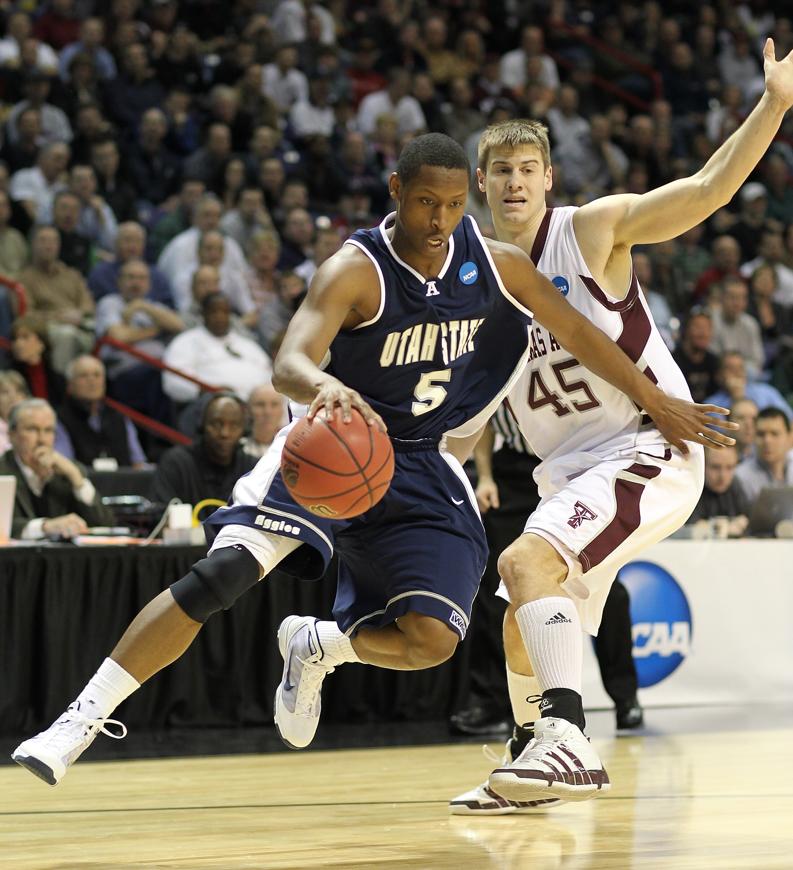 SPOKANE - MARCH 19:  Pooh Williams #5 of the Utah State Aggies  drives against Nathan Walkup #45 of the Texas A&M Aggies during the first round of the 2010 NCAA men's basketball tournament at the Spokane Arena on March 19, 2010 in Spokane, Washington. (Ph