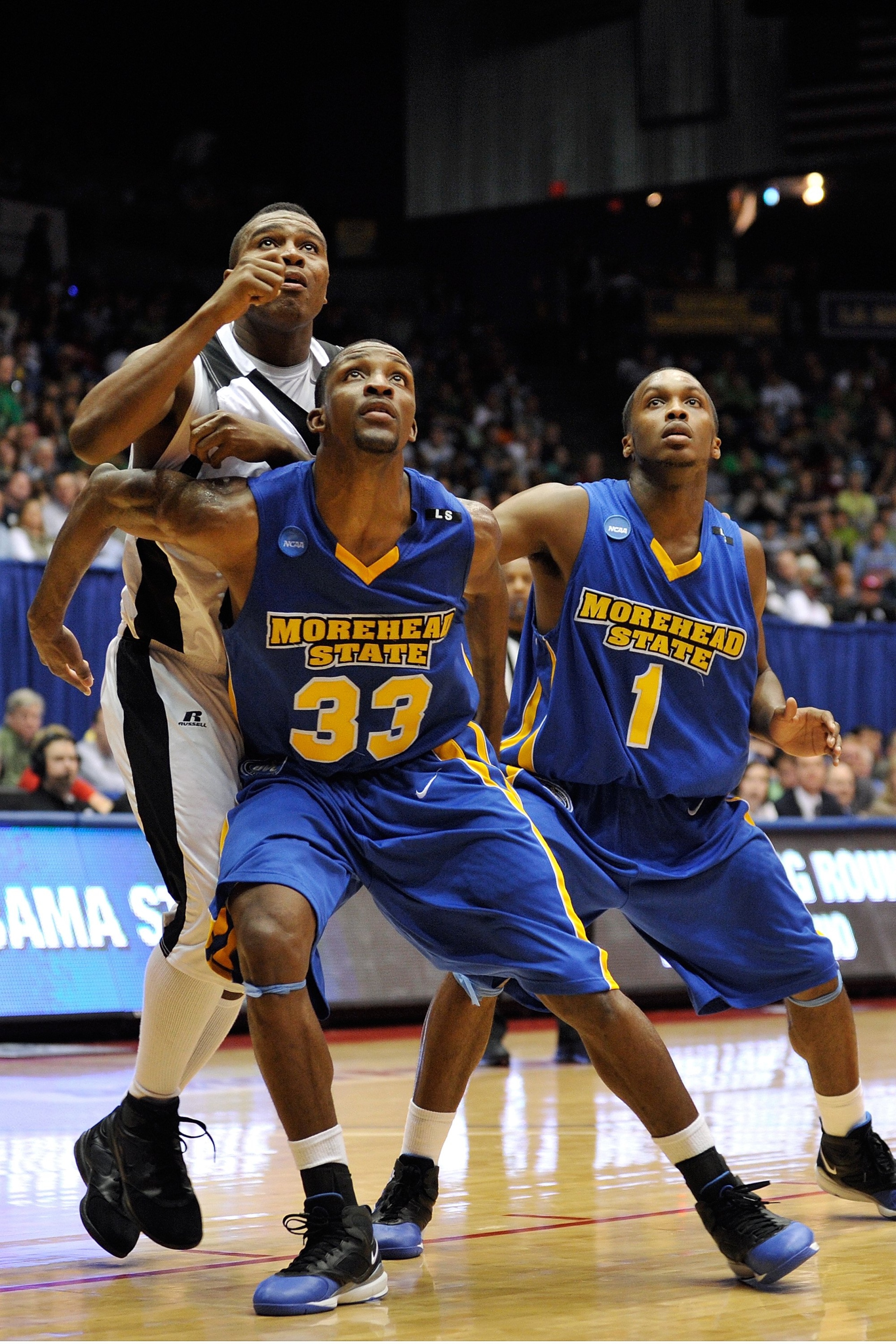 DAYTON, OH - MARCH 17: Leon Buchanan #33 and Maze Stallworth #1 of the Morehead State Eagles box out Tramaine Butler #21 of the Alabama State Hornets during the opening round of the Men's NCAA Tournament on March 17, 2009 at the University of Dayton Arena