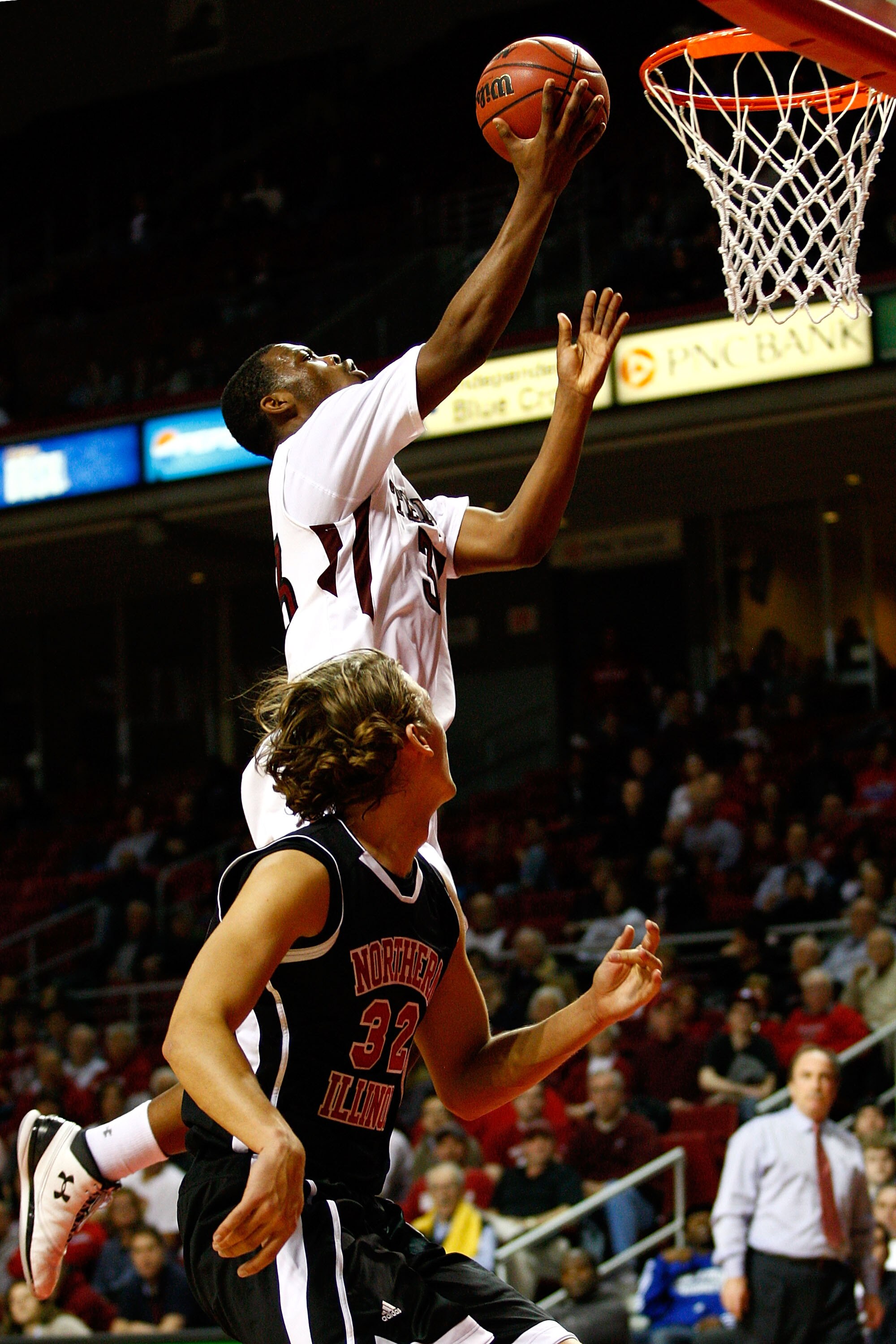 PHILADELPHIA, PA - DECEMBER 18: Scootie Randall #33 of the Temple Owls drives for a shot attempt against Aksel Bolin #32 of the Northern Illinois Huskies at the Liacouras Center on December 18, 2010 in Philadelphia, Pennsylvania. (Photo by Chris Chambers/