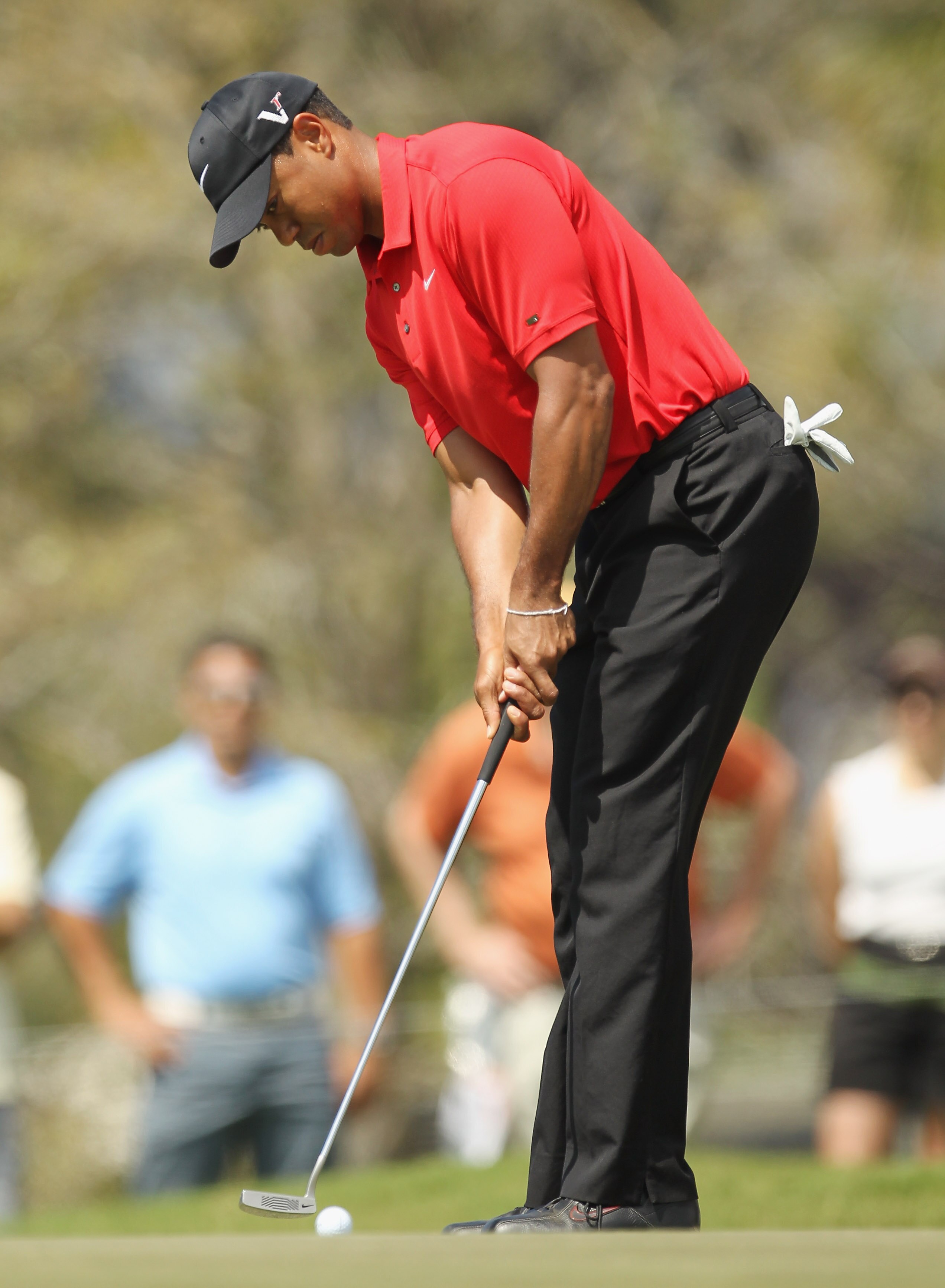 DORAL, FL - MARCH 13:  Tiger Woods hits a putt during the final round of the 2011 WGC- Cadillac Championship at the TPC Blue Monster at the Doral Golf Resort and Spa on March 13, 2011 in Doral, Florida.  (Photo by Mike Ehrmann/Getty Images)