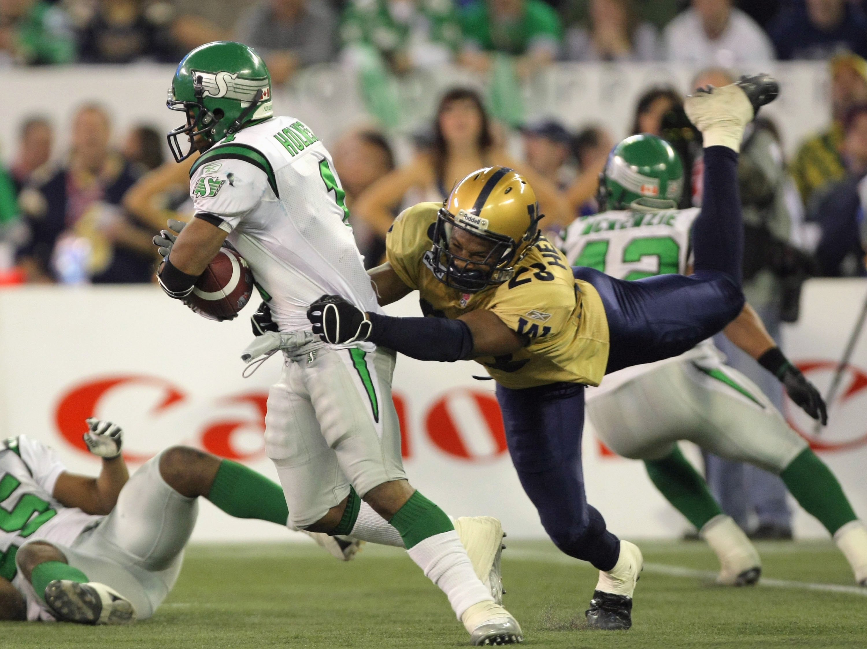 TORONTO - NOVEMBER 25:  O'Neil Wilson #1 of the Saskatchewan Rough Riders breaks away from the tackle of Kyries Hebert #23 of the Winnipeg Blue Bombers during the third quarter in the 95th Grey Cup on November 25, 2007 at the Rogers Centre in Toronto, Ont