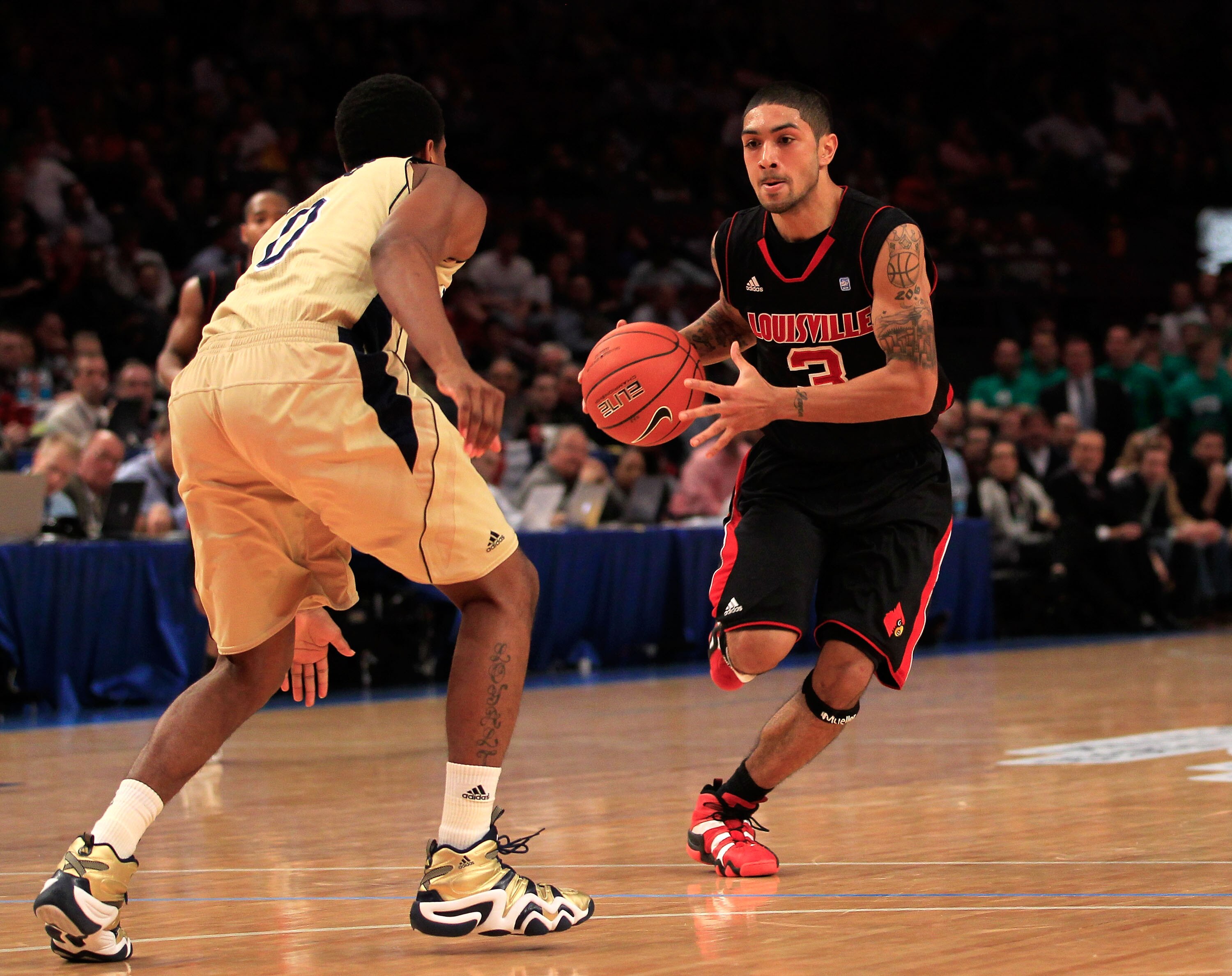 NEW YORK, NY - MARCH 11: Peyton Siva #3 of the Louisville Cardinals brings the ball up court against Eric Atkins #0 of the Notre Dame Fighting Irish  during the semifinals of the 2011 Big East Men's Basketball Tournament presented by American Eagle Outfit