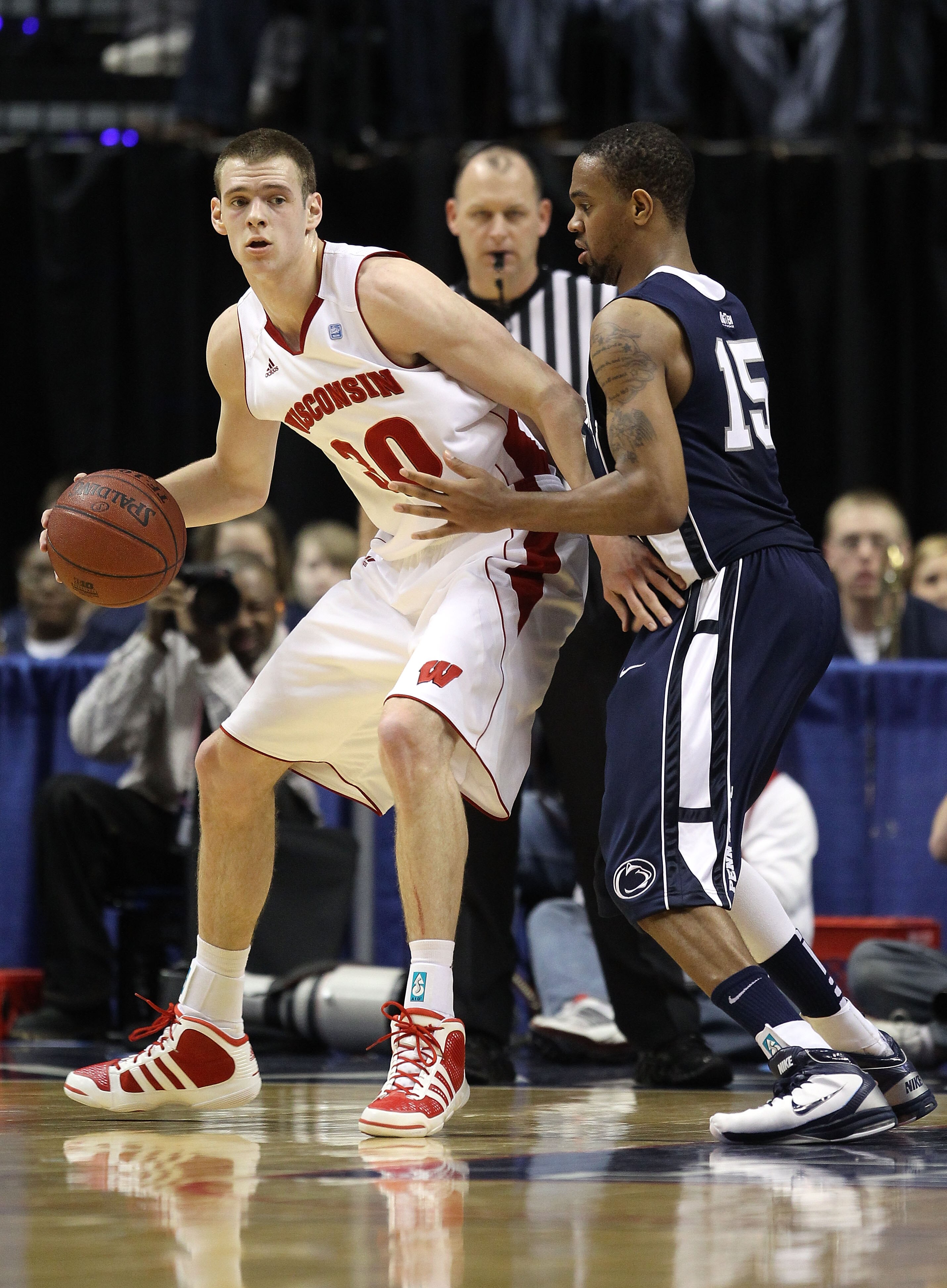 INDIANAPOLIS, IN - MARCH 11:  Jon Leuer #30 of the Wisconsin Badgers posts up against David Jackson #15 of the Penn State Nittany Lions during the quarterfinals of the 2011 Big Ten Men's Basketball Tournament at Conseco Fieldhouse on March 11, 2011 in Ind