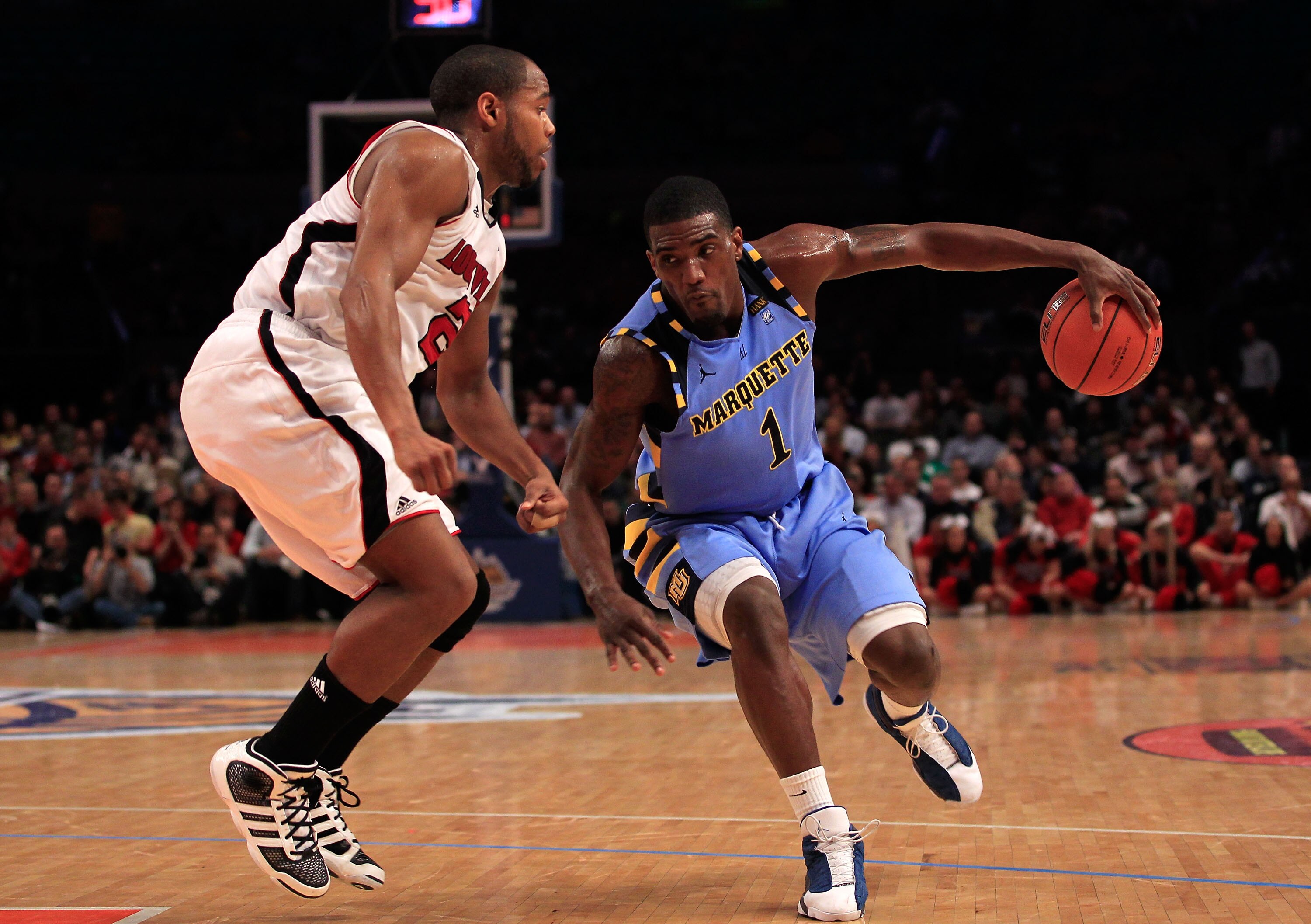 NEW YORK, NY - MARCH 10: Darius Johnson-Odom #1 of the Marquette Golden Eagles handles the ball against Preston Knowles #2 of the Louisville Cardinals during the quarterfinals of the 2011 Big East Men's Basketball Tournament presented by American Eagle Ou NEW YORK, NY - MARCH 10: Darius Johnson-Odom #1 of the Marquette Golden Eagles handles the ball against Preston Knowles #2 of the Louisville Cardinals during the quarterfinals of the 2011 Big East Men's Basketball Tournament presented by American Eagle Ou