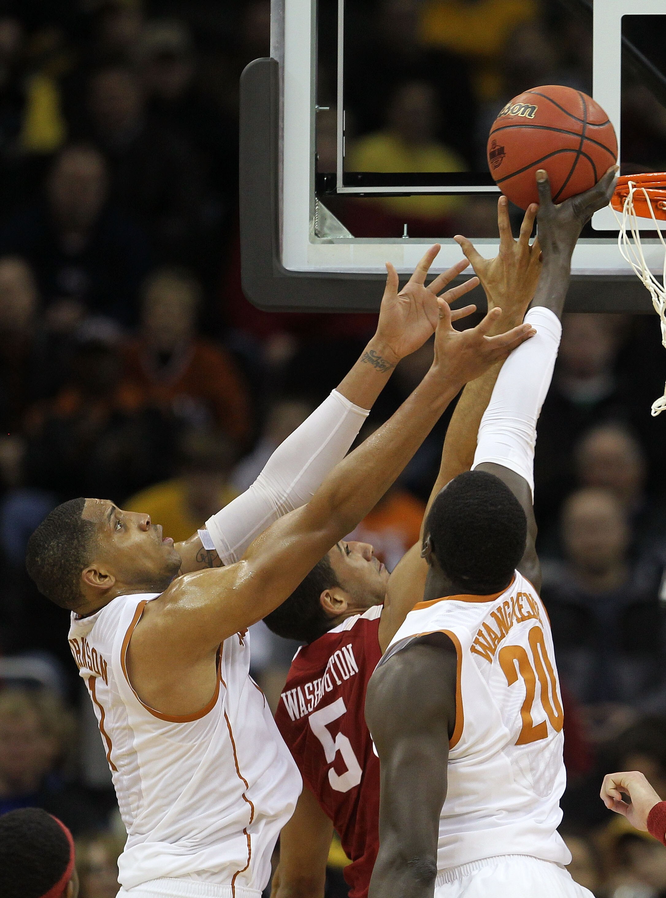 KANSAS CITY, MO - MARCH 10:  Gary Johnson #1 and Alexis Wangmene #20 of the Texas Longhorns fight for a rebound with C.J. Washington #5 of the Oklahoma Sooners during their quarterfinal game in the 2011 Phillips 66 Big 12 Men's Basketball Tournament at Sp