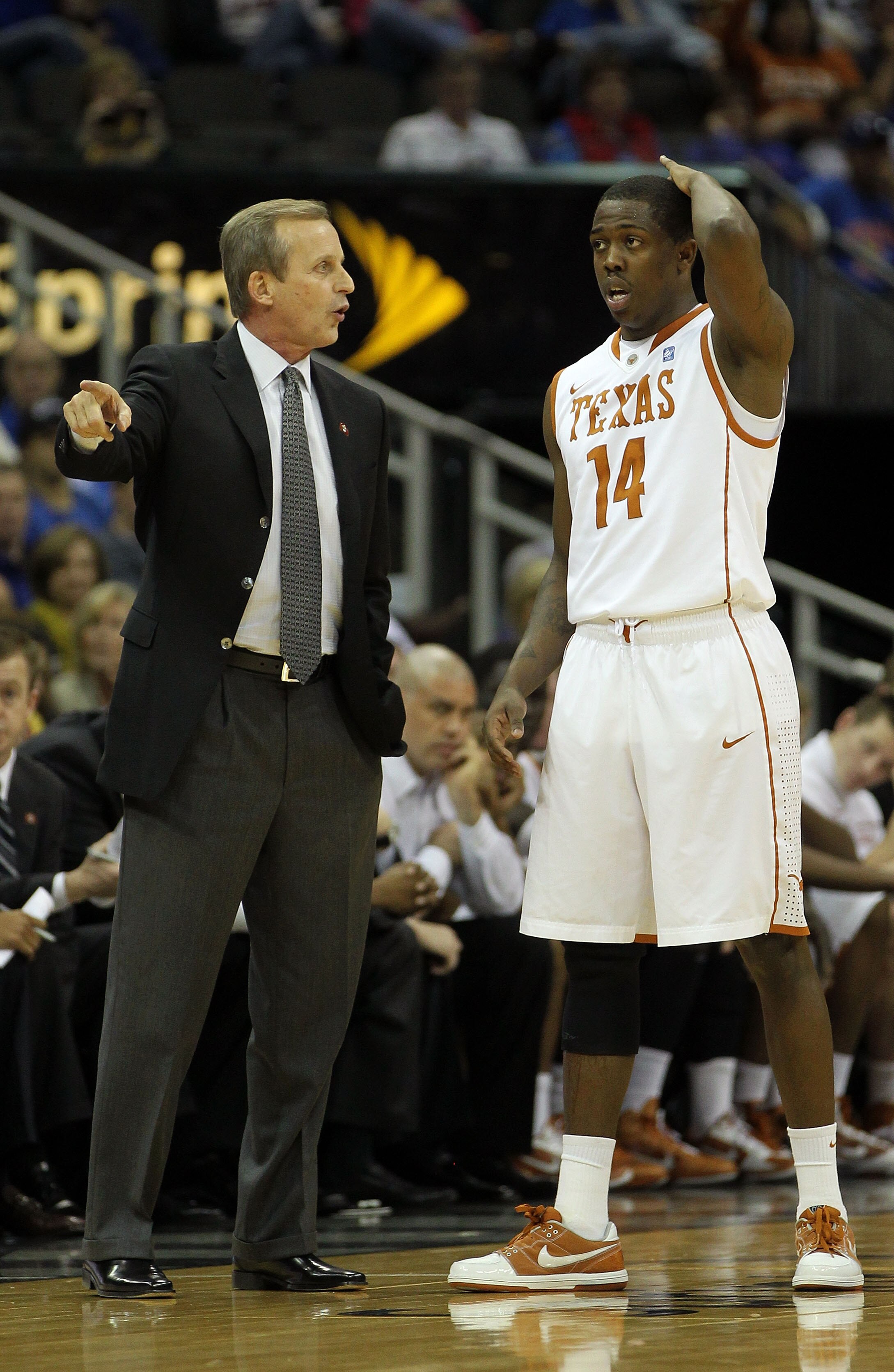 KANSAS CITY, MO - MARCH 11:  Head coach Rick Barnes of the Texas Longhorns speaks with J'Covan Brown #14 during their semifinal game against the Texas A&M Aggies in the 2011 Phillips 66 Big 12 Men's Basketball Tournament at Sprint Center on March 11, 2011