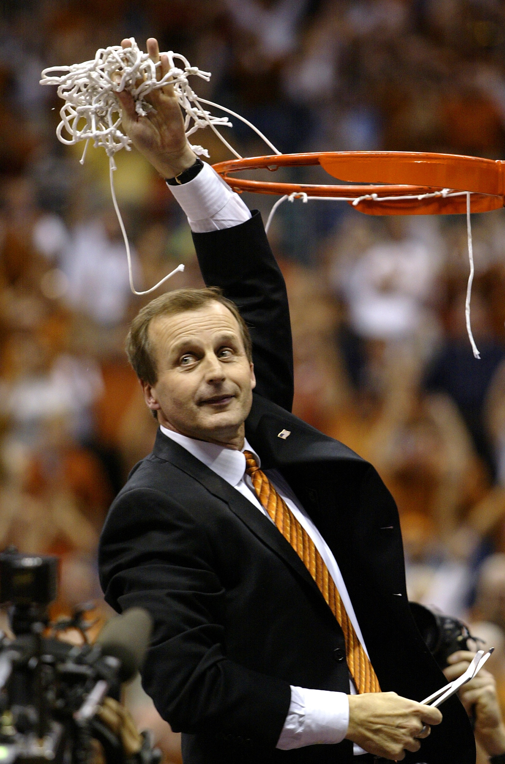 SAN ANTONIO - MARCH 30:  Head coach Rick Barnes of the Texas Longhorns holds up the net after defeating the Michigan State Spartans 85-76 during the NCAA Division I Men's Championship South Regional Final on March 30, 2003 in San Antonio, Texas.  Texas wi