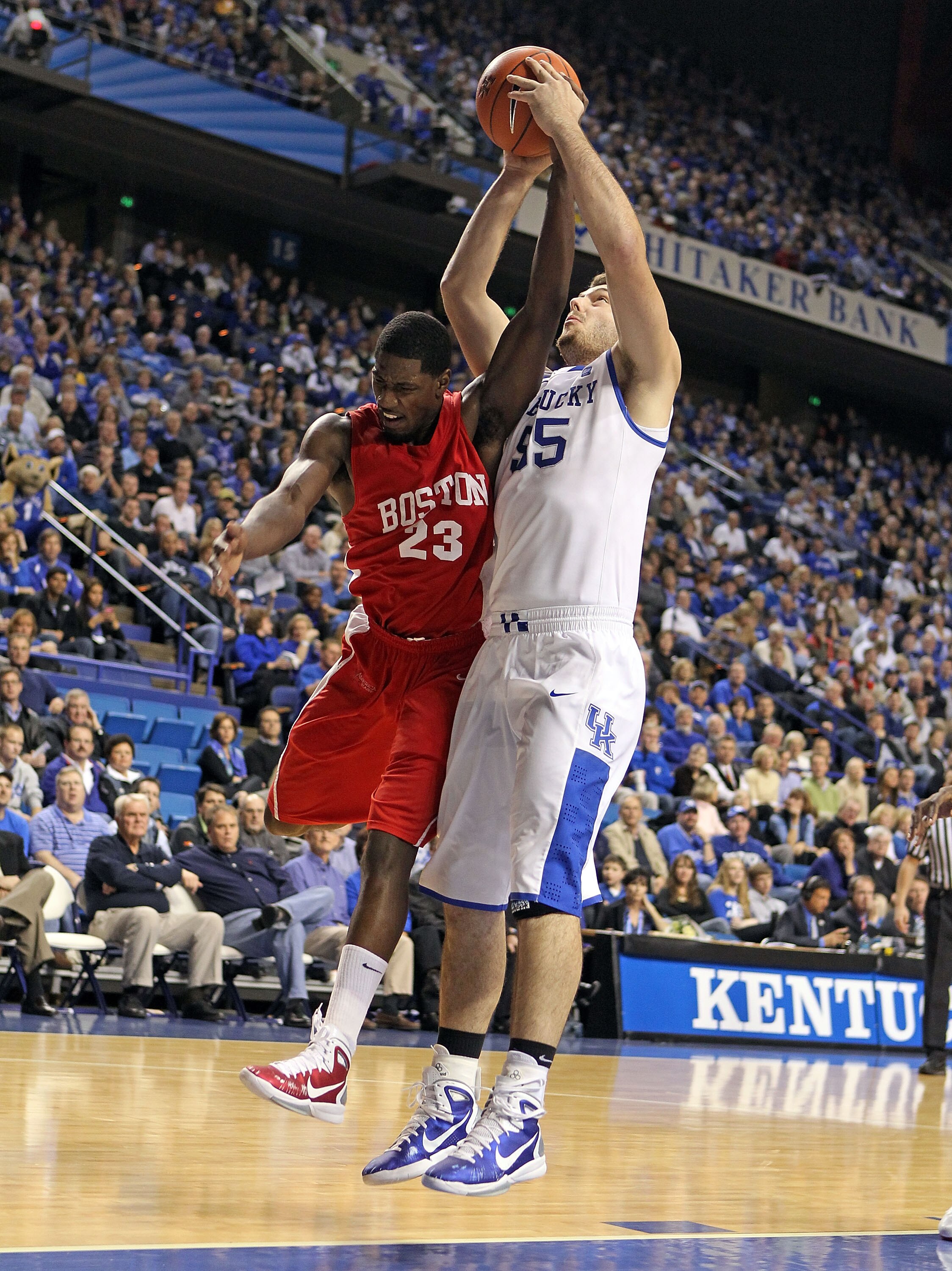 LEXINGTON, KY - NOVEMBER 30: Josh Harrellson #55 of the Kentucky Wildcats and John Holland #23 of the Boston University Terriers battle for a rebound during the game on November 30, 2010 in Lexington, Kentucky. Kentucky won 91-57. (Photo by Andy Lyons/G LEXINGTON, KY - NOVEMBER 30: Josh Harrellson #55 of the Kentucky Wildcats and John Holland #23 of the Boston University Terriers battle for a rebound during the game on November 30, 2010 in Lexington, Kentucky. Kentucky won 91-57. (Photo by Andy Lyons/G