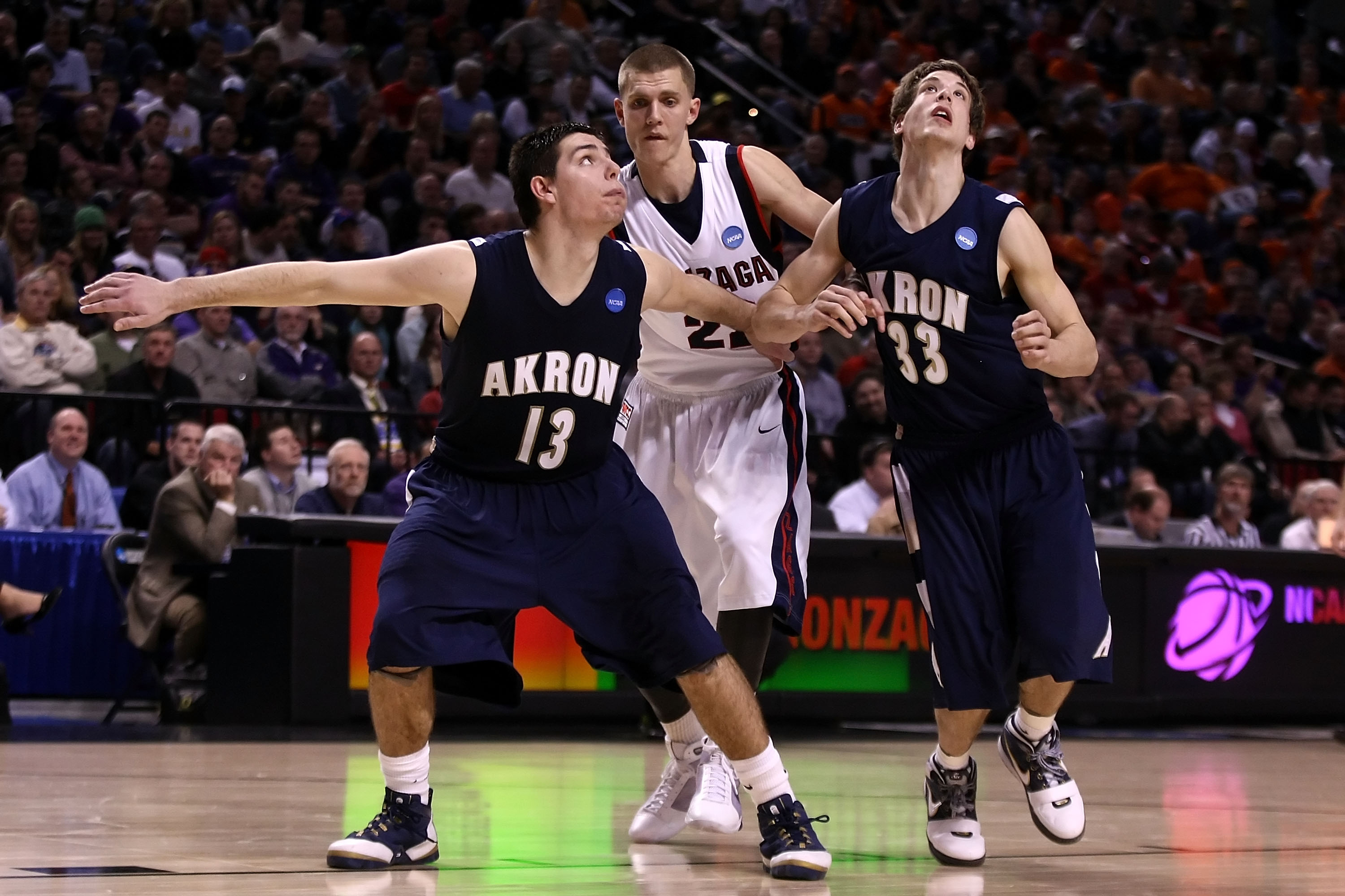 PORTLAND, OR - MARCH 19: Nikola Cvetinovic #13 and Nate Linhart #33 of the Akron Zips box out Micah Downs #22 of the Gonzaga Bulldogs in the second half during the first round of the NCAA Division I Men's Basketball Tournament at the Rose Garden on March PORTLAND, OR - MARCH 19: Nikola Cvetinovic #13 and Nate Linhart #33 of the Akron Zips box out Micah Downs #22 of the Gonzaga Bulldogs in the second half during the first round of the NCAA Division I Men's Basketball Tournament at the Rose Garden on March
