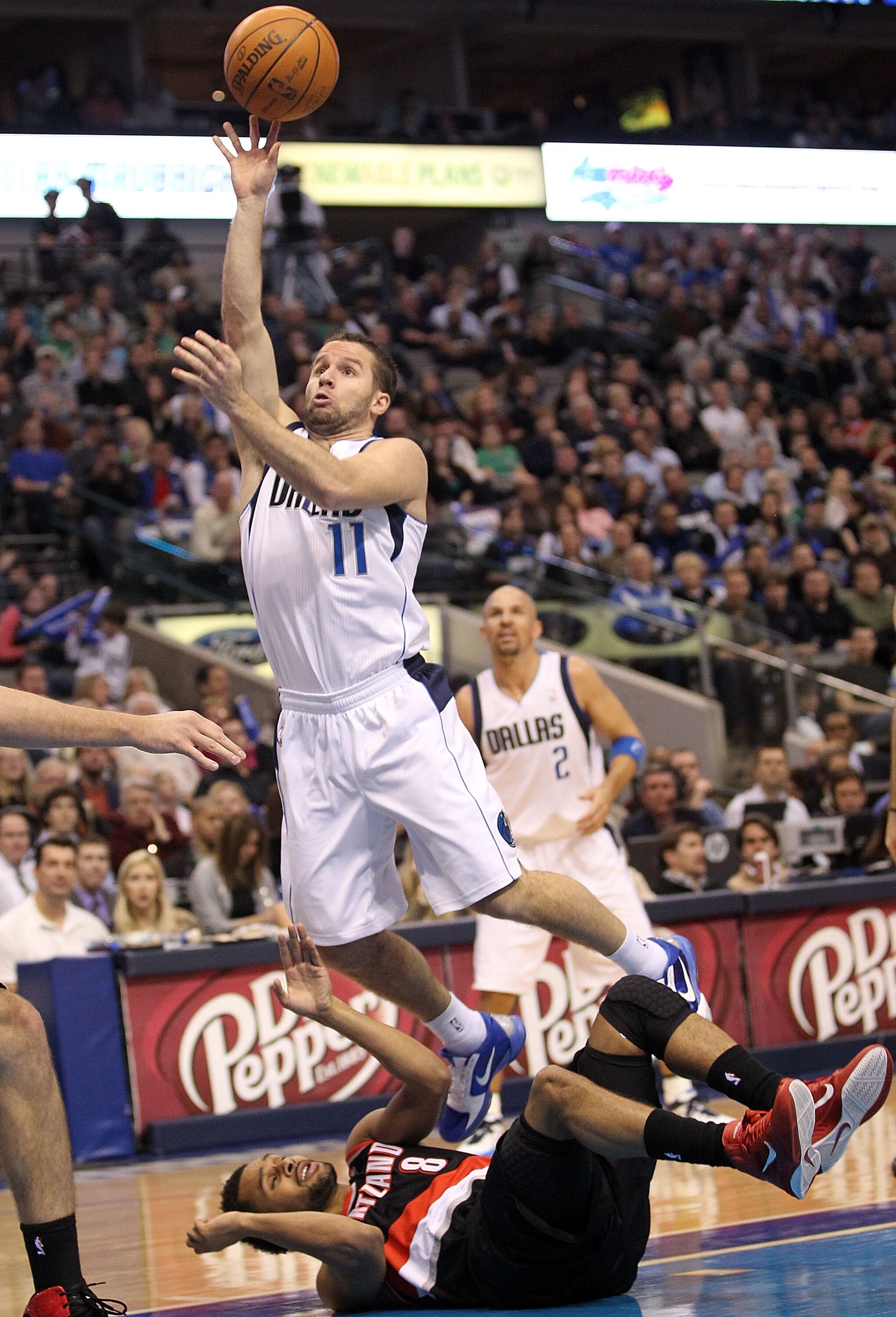 DALLAS, TX - JANUARY 04:  Guard Jose Juan Barea #11 of the Dallas Mavericks takes a shot against Patrick Mills #8 of the Portland Trail Blazers at American Airlines Center on January 4, 2011 in Dallas, Texas.  NOTE TO USER: User expressly acknowledges and