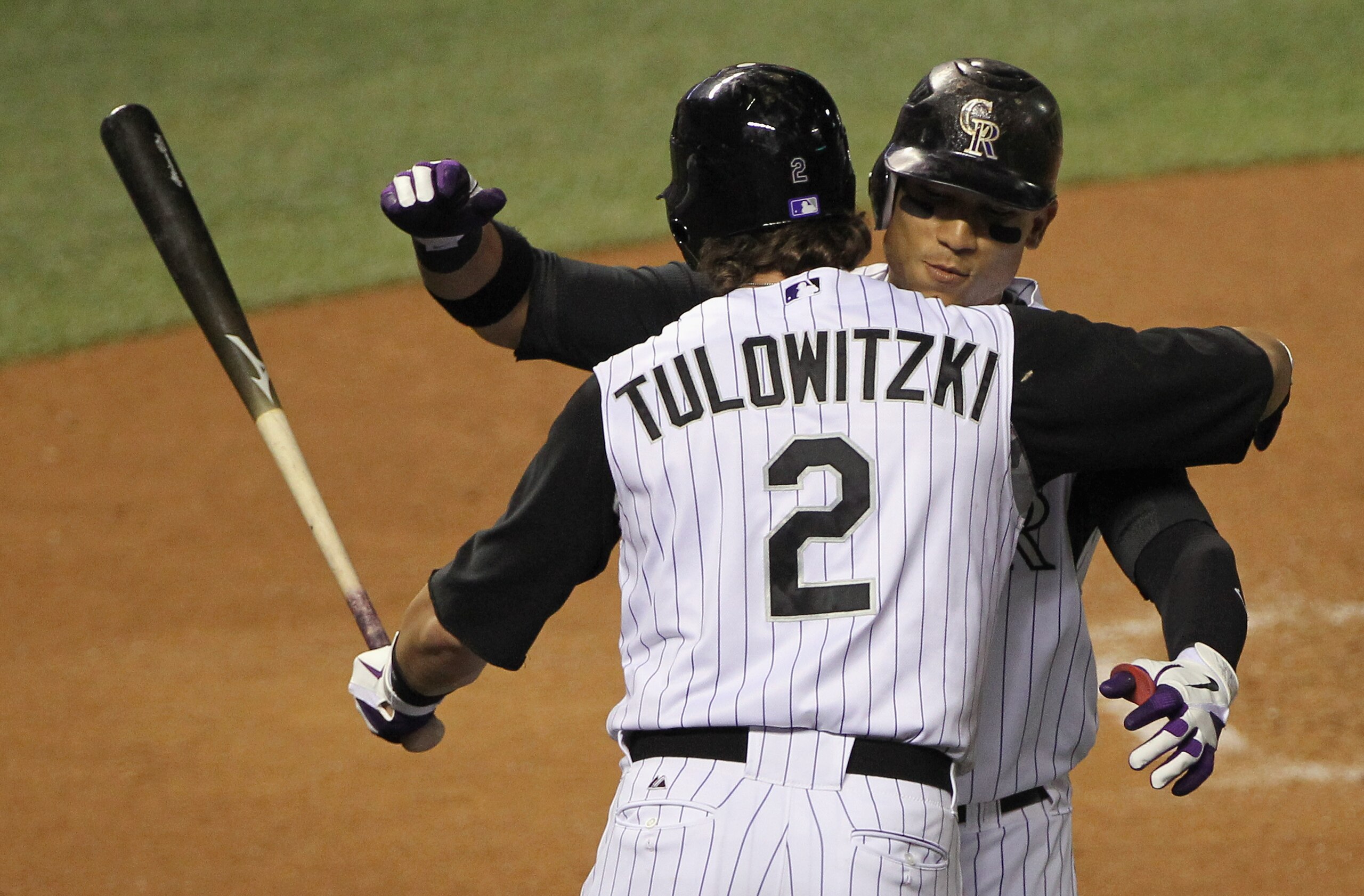 DENVER - SEPTEMBER 27: Troy Tulowitzki #2 welcomes Carlos Gonzalez #5 of the Colorado Rockies home after his solo home run against the Los Angeles Dodgers at Coors Field on September 25, 2010 in Denver, Colorado. (Photo by Doug Pensinger/Getty Images) DENVER - SEPTEMBER 27: Troy Tulowitzki #2 welcomes Carlos Gonzalez #5 of the Colorado Rockies home after his solo home run against the Los Angeles Dodgers at Coors Field on September 25, 2010 in Denver, Colorado. (Photo by Doug Pensinger/Getty Images)