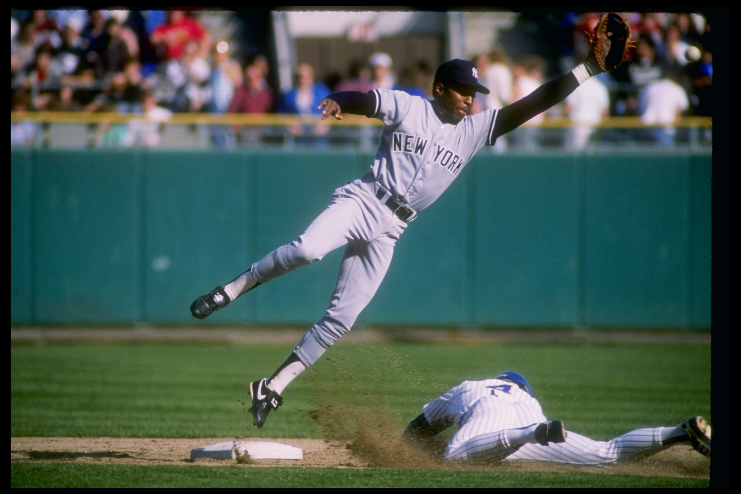 Infielder Willie Randolph of the New York Yankees (left) in action during a game.