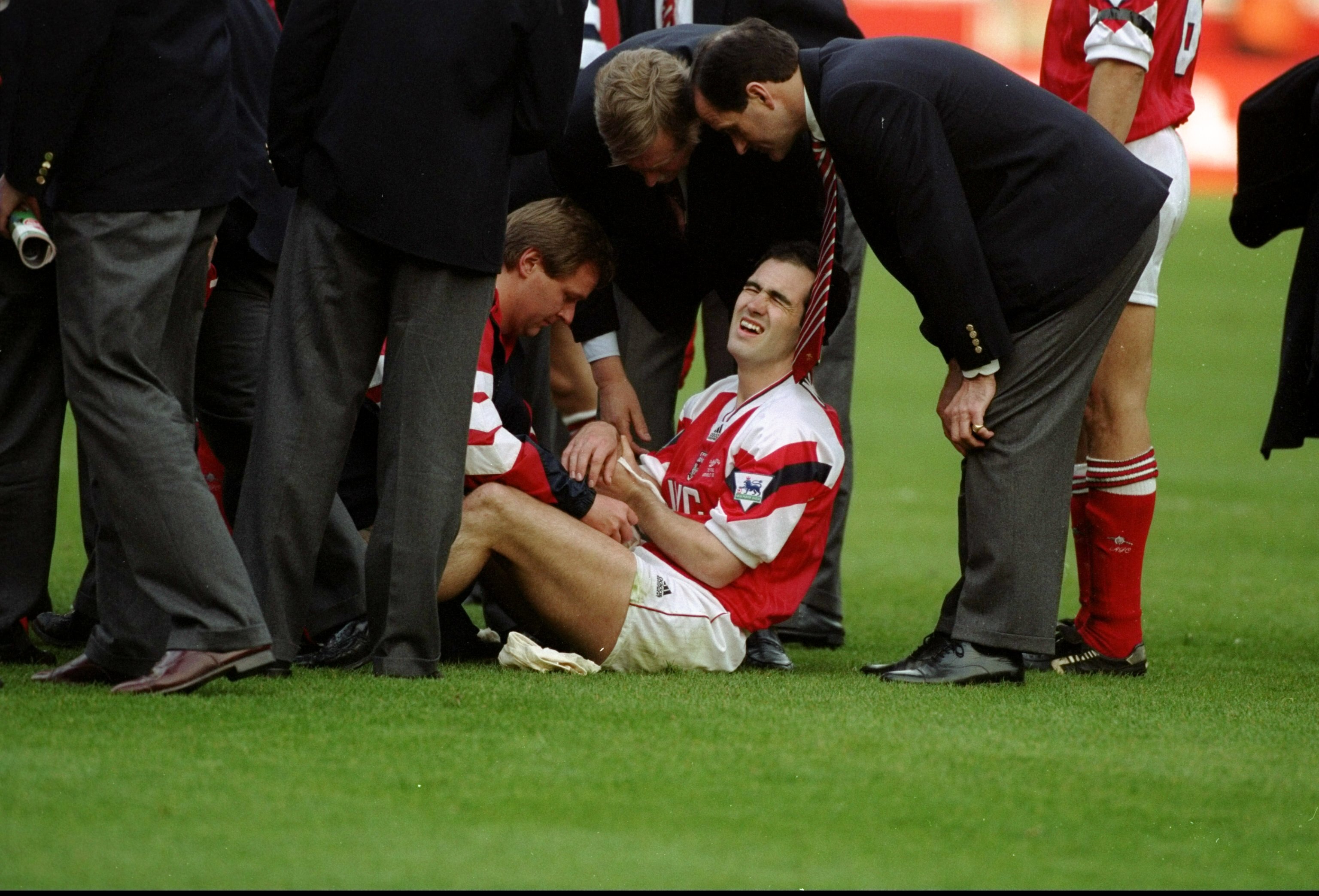 1993:  Steve Morrow of Arsenal sits in pain after being dropped by team mate Tony Adams during the celebrations after the Coca Cola Cup final against Sheffield Wednesday at Wembley Stadium in London. Arsenal won the match 2-1. \ Mandatory Credit: David  C