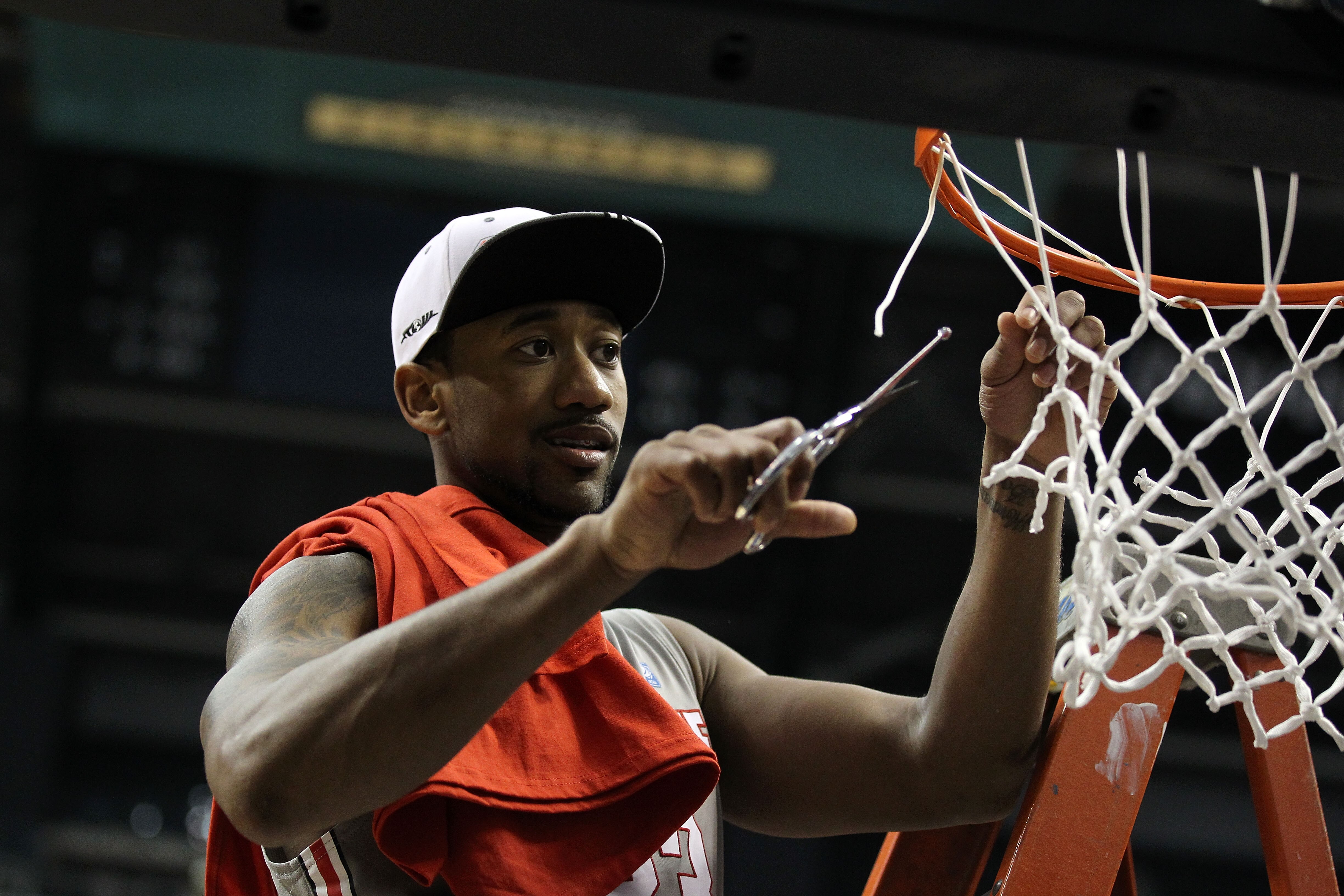 INDIANAPOLIS, IN - MARCH 13:  David Lighty #23 of the Ohio State Buckeyes cuts down a piece of the net in celebration of their 71-60 win against the Penn State Nittany Lions during the championship game of the 2011 Big Ten Men's Basketball Tournament at C