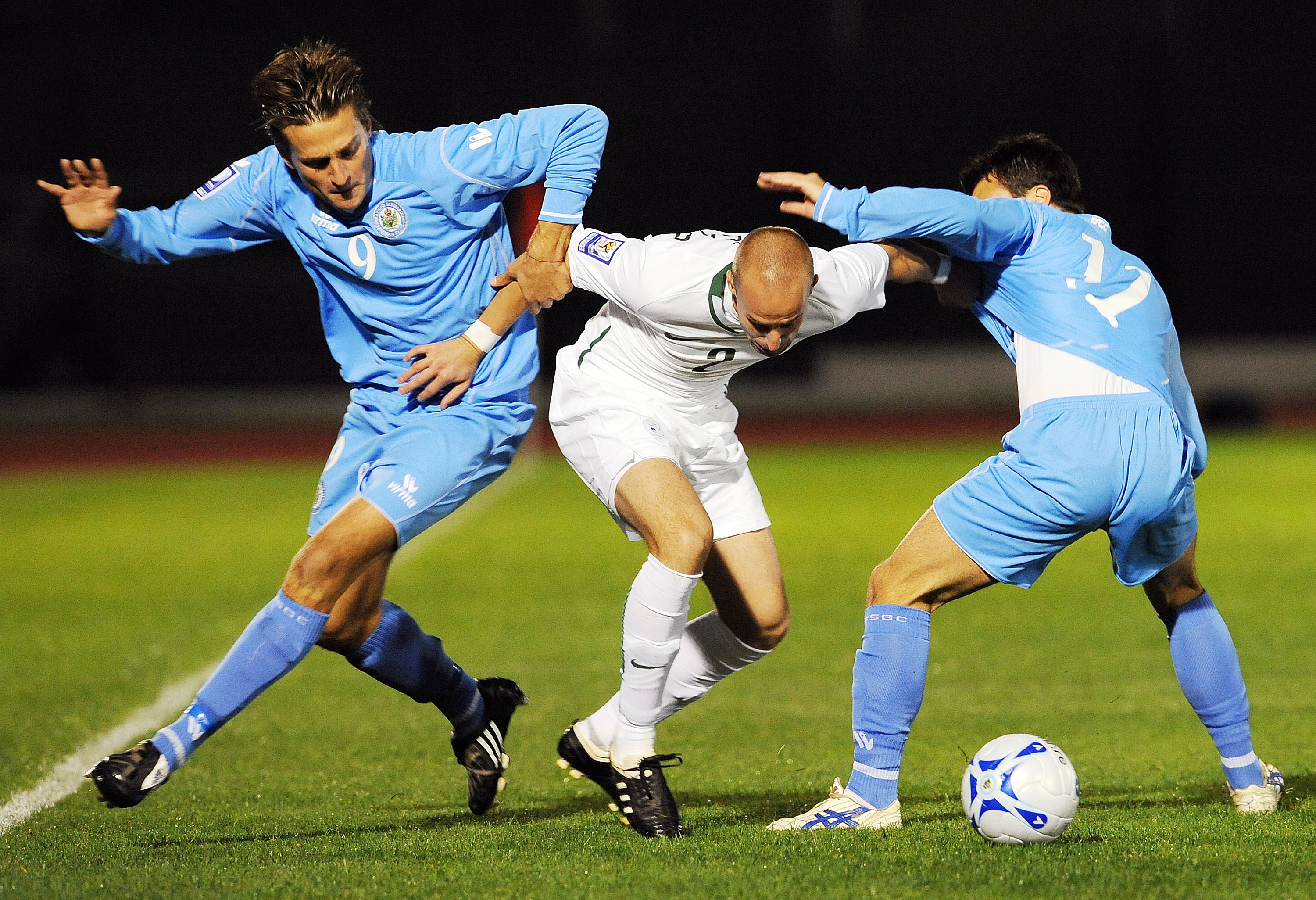 SERRAVALLE, ITALY - OCTOBER 14:  Manuel Marani of San Marino and Miso Brecko of Slovenia and Matteo Vitaioli of San Marino in action during the FIFA 2010 World Cup Group 3 Qualifying match between San Marino and Slovenia at Stadio Olimpico on October 14,