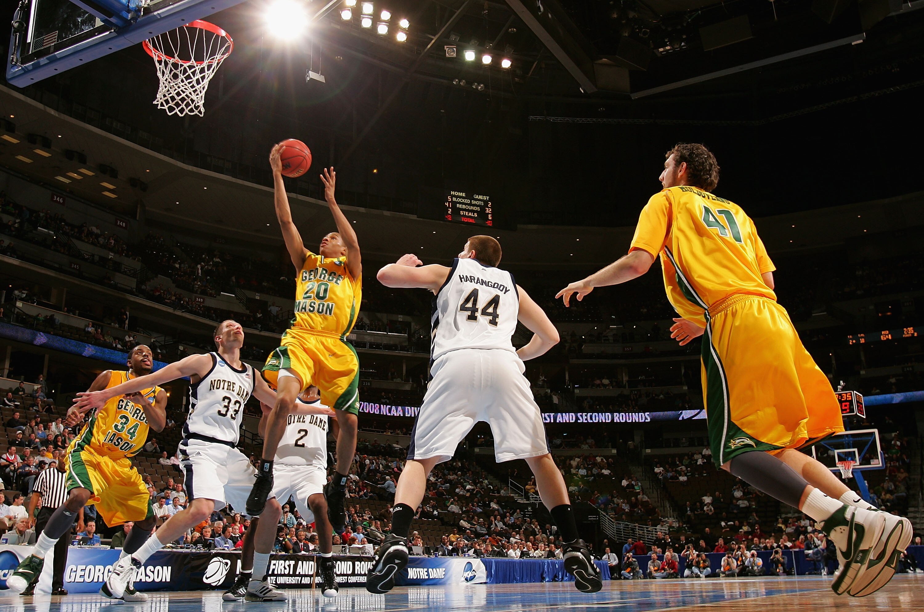 DENVER - MARCH 20: Cam Long #20 of the George Mason Patriots lays up a shot against Zach Hillesland #33 of the Notre Dame Fighting Irish during the first round of the East Regional as part of the 2008 NCAA Men's Basketball Tournament at Pepsi Center on M DENVER - MARCH 20: Cam Long #20 of the George Mason Patriots lays up a shot against Zach Hillesland #33 of the Notre Dame Fighting Irish during the first round of the East Regional as part of the 2008 NCAA Men's Basketball Tournament at Pepsi Center on M