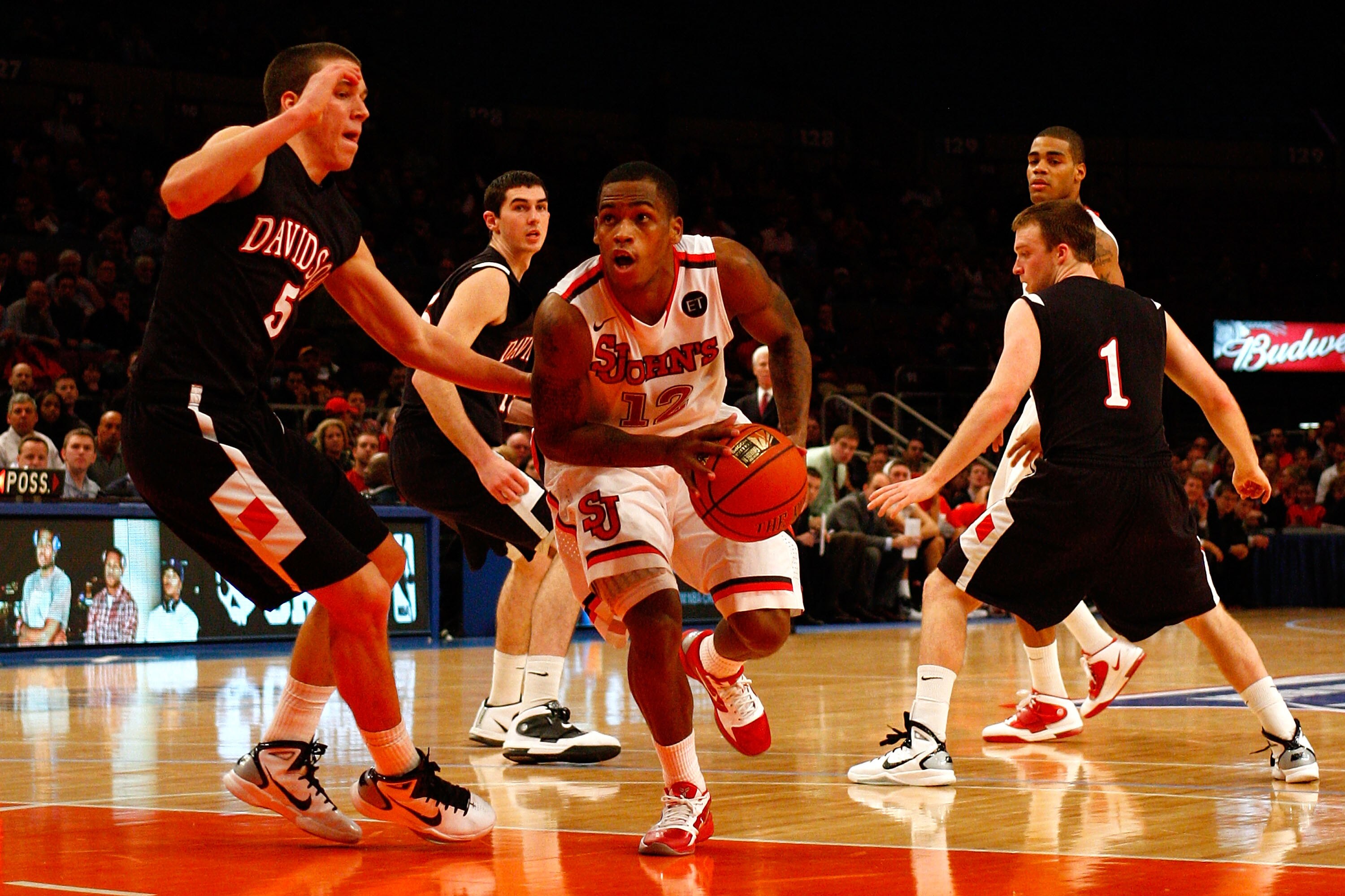 NEW YORK, NY - DECEMBER 20: Dwight Hardy #12 of the St. John's Red Storm drives against JP Kuhlman #5 and Brendan McKillop #1 of the Davidson Wildcats during the Madison Square Garden Holiday Festival at Madison Square Garden on December 20, 2010 in New NEW YORK, NY - DECEMBER 20: Dwight Hardy #12 of the St. John's Red Storm drives against JP Kuhlman #5 and Brendan McKillop #1 of the Davidson Wildcats during the Madison Square Garden Holiday Festival at Madison Square Garden on December 20, 2010 in New