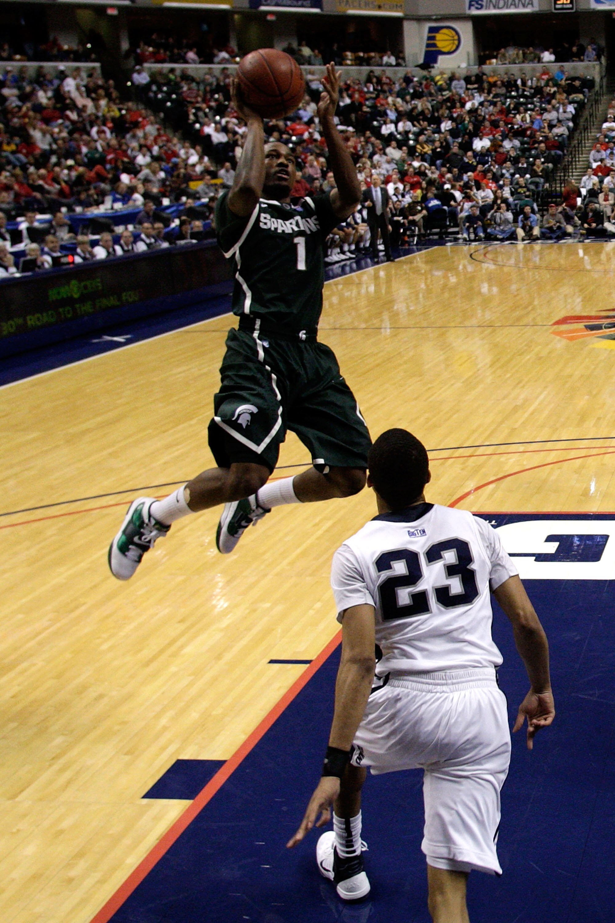 INDIANAPOLIS, IN - MARCH 12:  Kalin Lucas #1 of the Michigan State Spartans attempts a shot against Tim Frazier #23 of the Penn State Nittany Lions  during the semifinals of the 2011 Big Ten Men's Basketball Tournament at Conseco Fieldhouse on March 12, 2