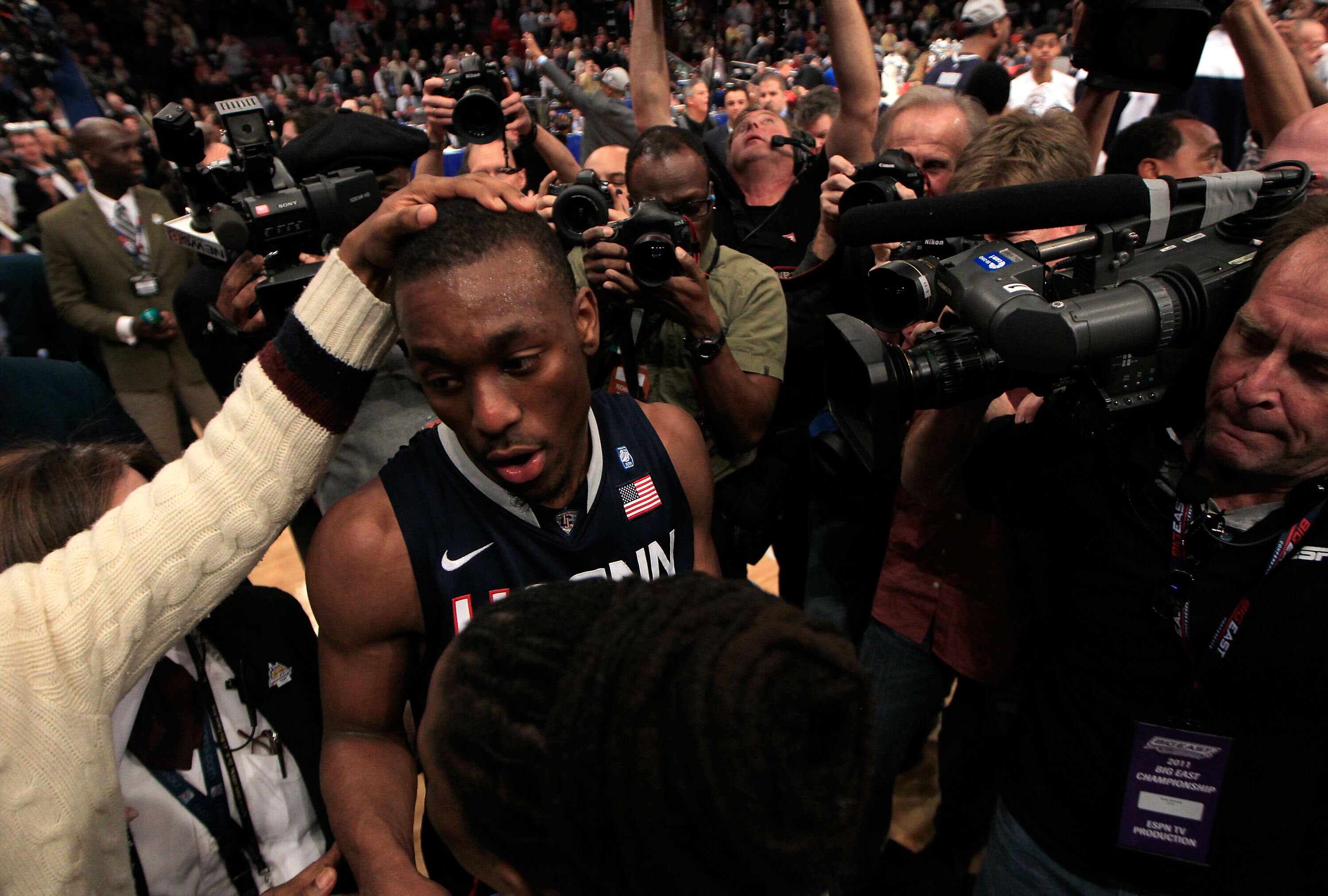 NEW YORK, NY - MARCH 12:  Kemba Walker #15 of the Connecticut Huskies is surrounded by media after defeating the Louisville Cardinals during the championship of the 2011 Big East Men's Basketball Tournament presented by American Eagle Outfitters at Madiso