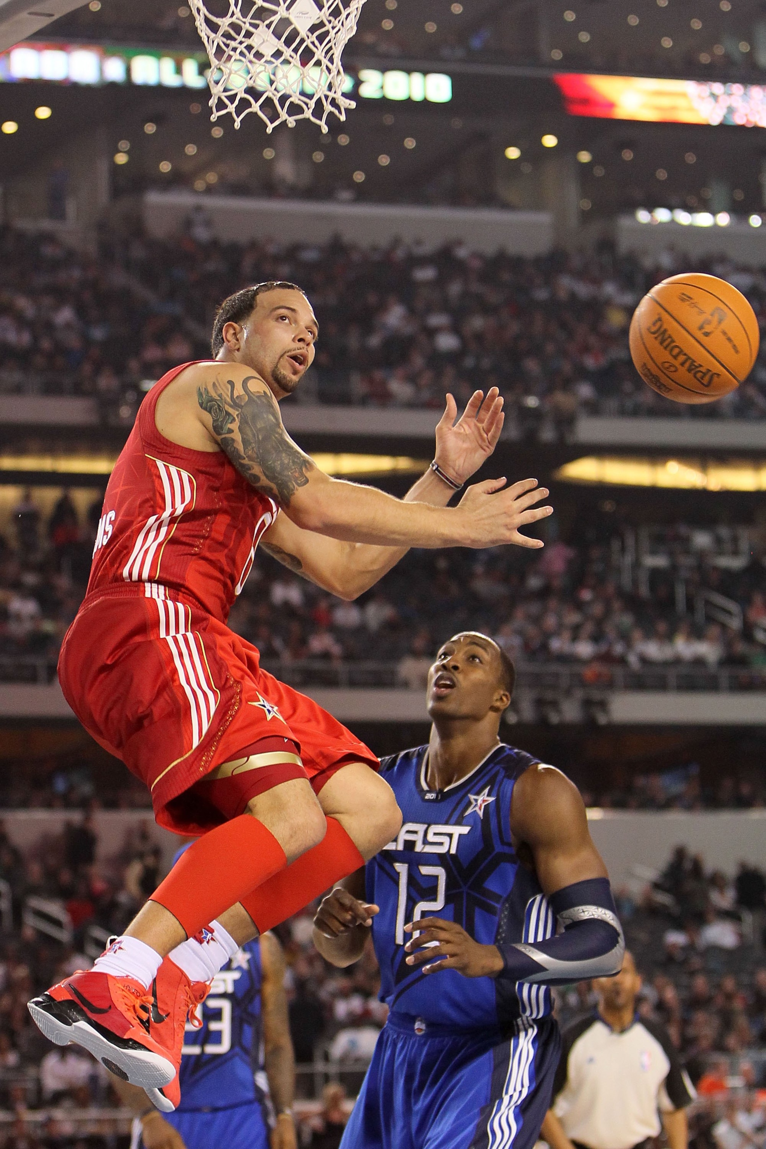 ARLINGTON, TX - FEBRUARY 14: Deron Williams #8 of the Western Conference passes against Dwight Howard #12 of the Eastern Conference during the NBA All-Star Game, part of 2010 NBA All-Star Weekend at Cowboys Stadium on February 14, 2010 in Arlington, Texa ARLINGTON, TX - FEBRUARY 14: Deron Williams #8 of the Western Conference passes against Dwight Howard #12 of the Eastern Conference during the NBA All-Star Game, part of 2010 NBA All-Star Weekend at Cowboys Stadium on February 14, 2010 in Arlington, Texa