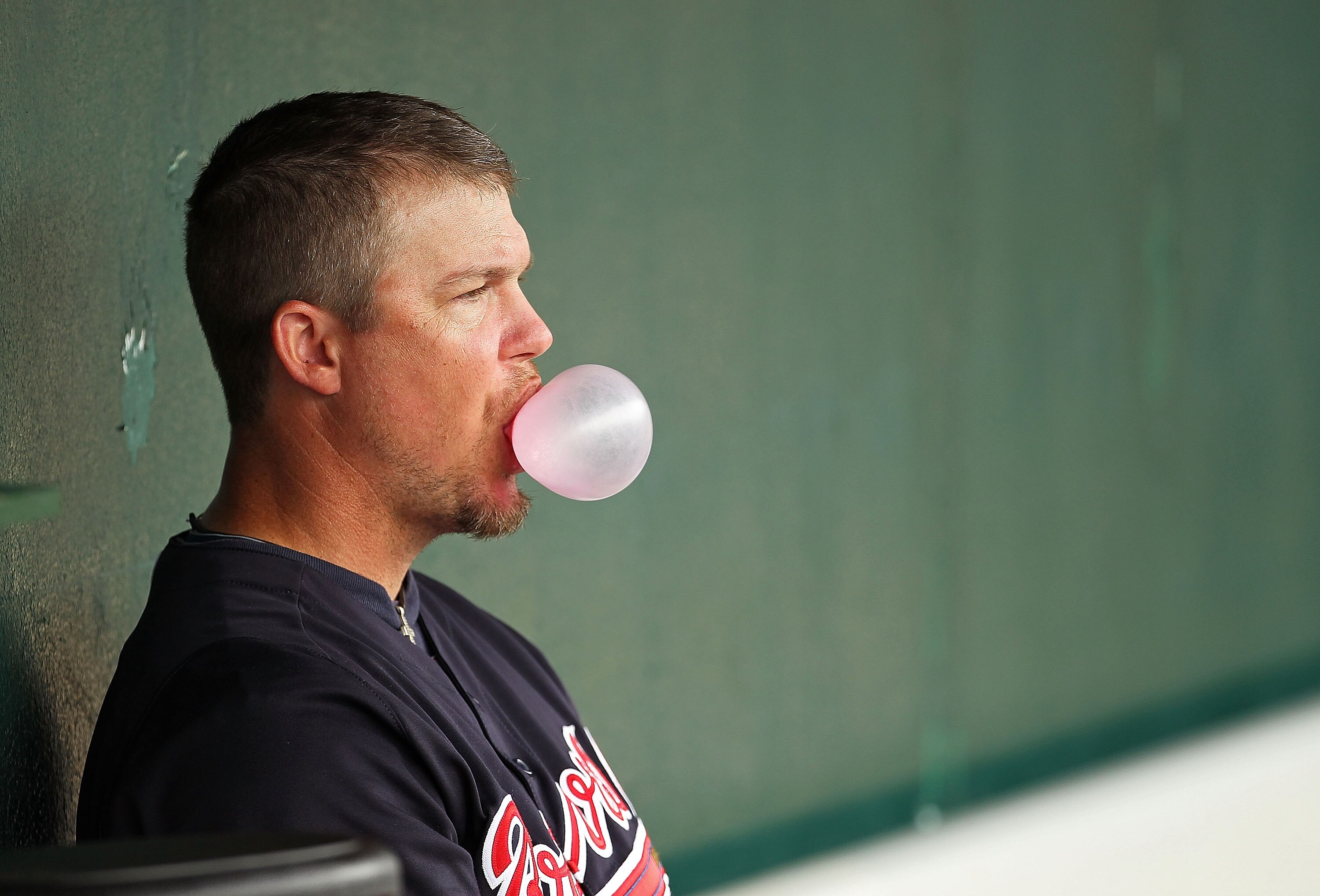 KISSIMMEE, FL - MARCH 01:  Chipper Jones #10 of the Atlanta Braves looks on from the dugout during a Spring Training game against the Houston Astros at Osceola County Stadium on March 1, 2011 in Kissimmee, Florida.  (Photo by Mike Ehrmann/Getty Images)