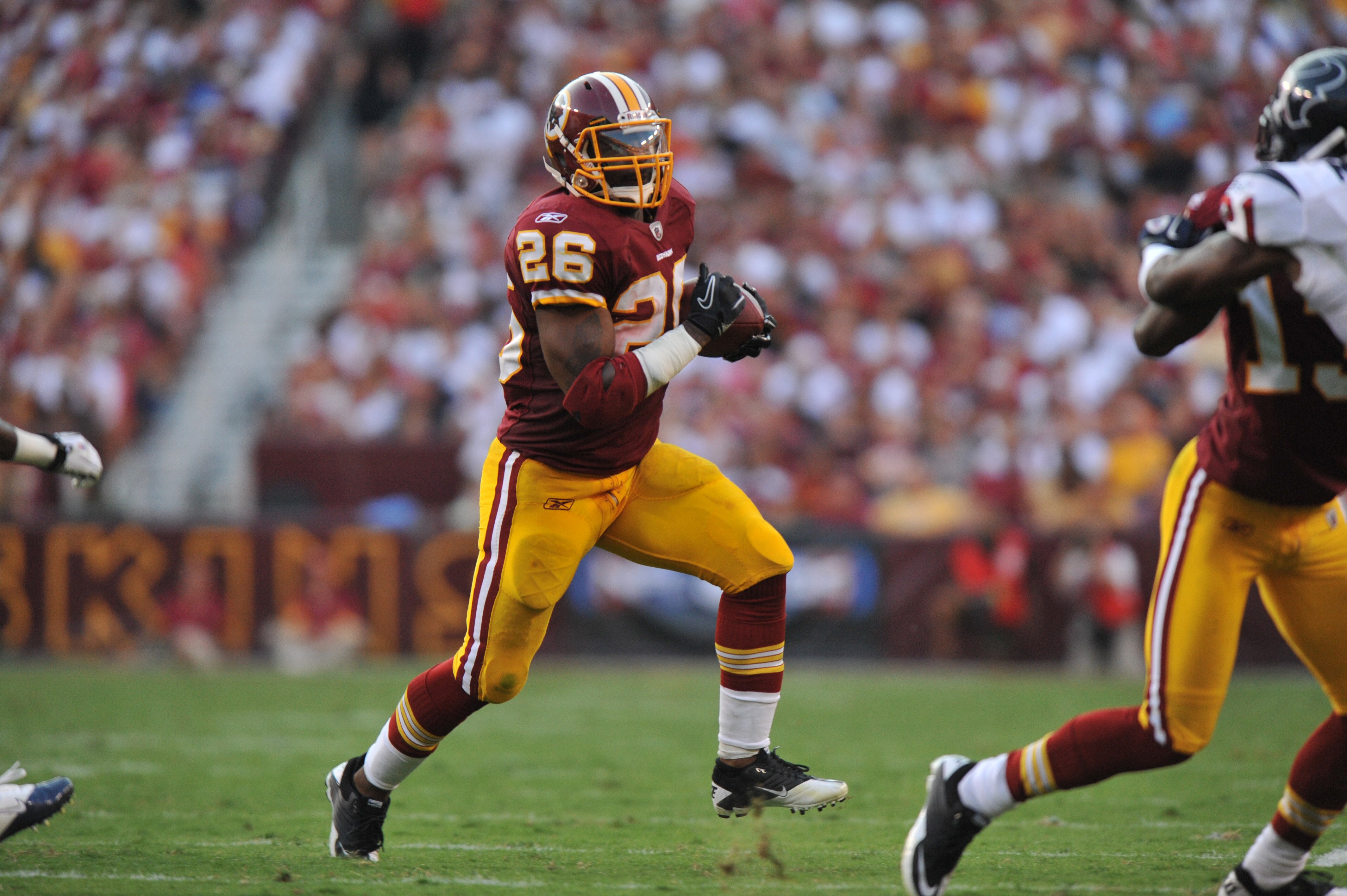 LANDOVER - SEPTEMBER 19:  Clinton Portis #26 of the Washington Redskins runs the ball during the game against the Houston Texans at FedExField on September 19, 2010 in Landover, Maryland. The Texans defeated the Redskins in overtime 30-27. (Photo by Larry