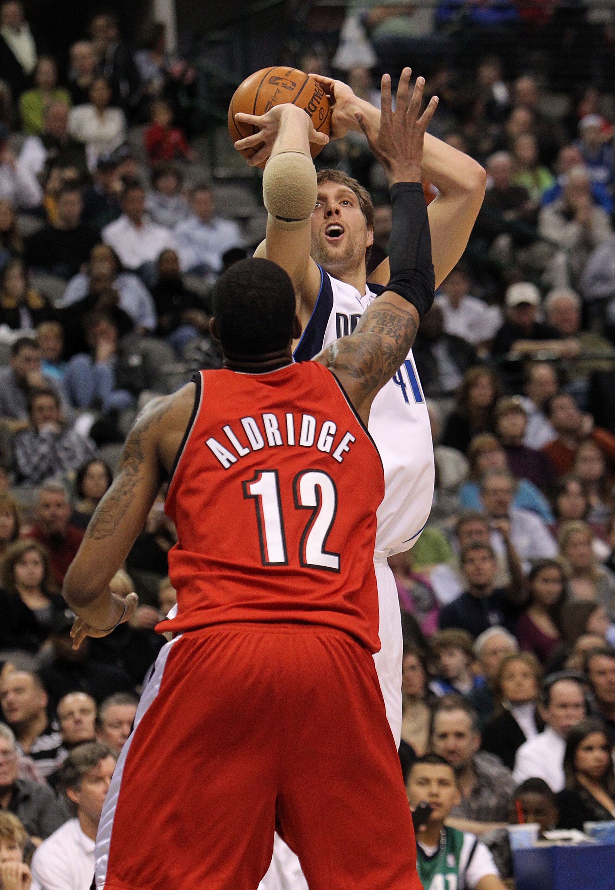 DALLAS - JANUARY 30: Forward Dirk Nowitzki #21 of the Dallas Mavericks takes a shot against LaMarcus Aldridge #12 of the Portland Trail Blazers on January 30, 2010 at American Airlines Center in Dallas, Texas. NOTE TO USER: User expressly acknowledges a DALLAS - JANUARY 30: Forward Dirk Nowitzki #21 of the Dallas Mavericks takes a shot against LaMarcus Aldridge #12 of the Portland Trail Blazers on January 30, 2010 at American Airlines Center in Dallas, Texas. NOTE TO USER: User expressly acknowledges a