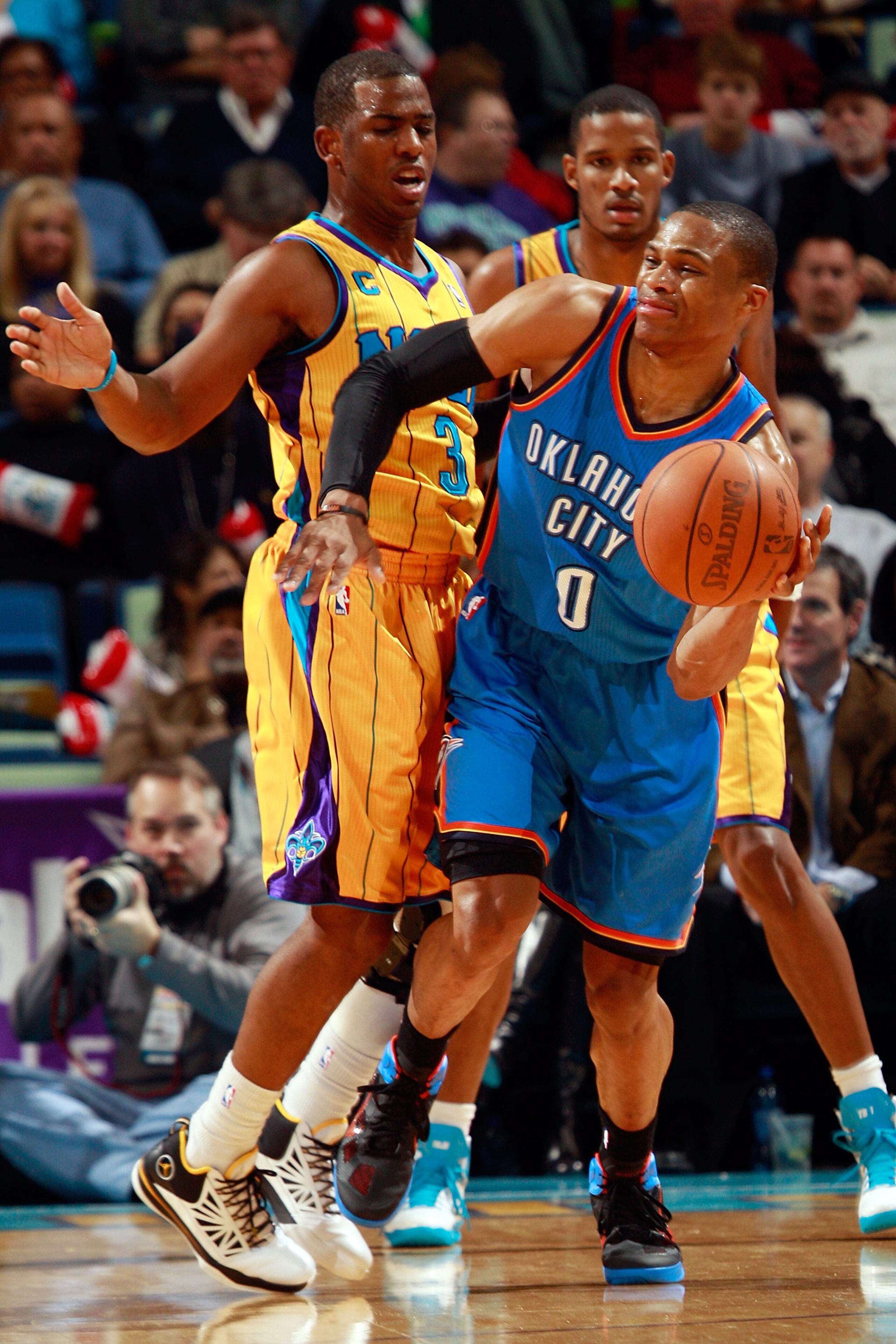 NEW ORLEANS, LA - DECEMBER 10: Russell Westbrook #0 of the Oklahoma City Thunder passes the ball around Chris Paul #3 of the New Orleans Hornets at New Orleans Arena on December 10, 2010 in New Orleans, Louisiana. The Thunder defeated the Hornets 97- NEW ORLEANS, LA - DECEMBER 10: Russell Westbrook #0 of the Oklahoma City Thunder passes the ball around Chris Paul #3 of the New Orleans Hornets at New Orleans Arena on December 10, 2010 in New Orleans, Louisiana. The Thunder defeated the Hornets 97-