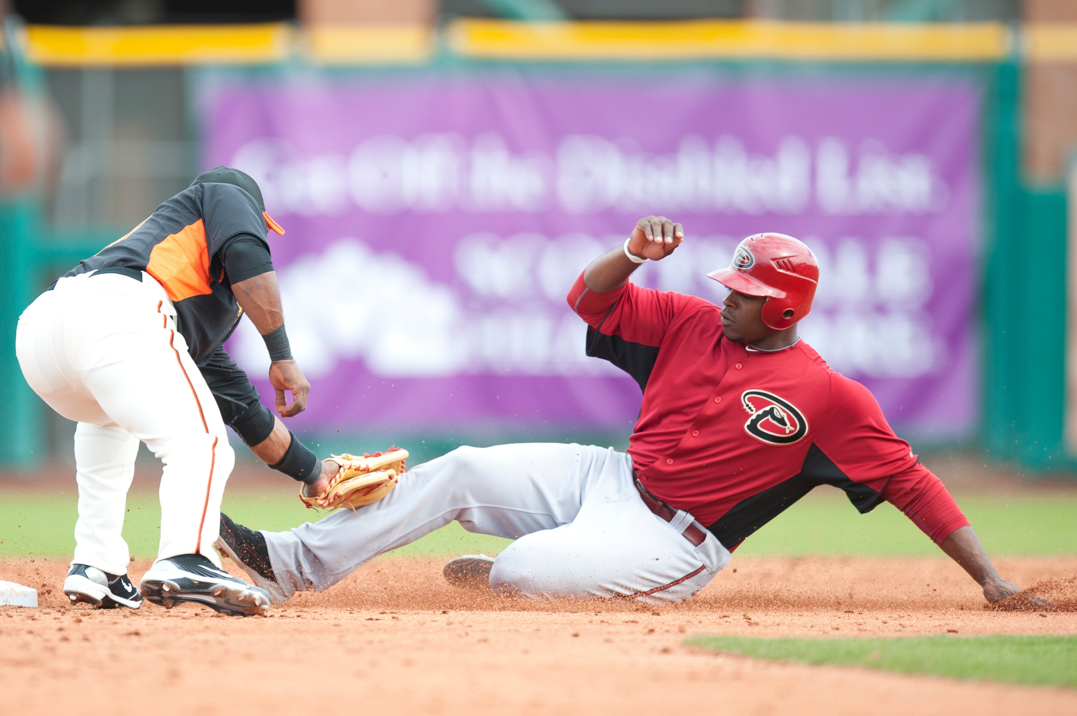 SCOTTSDALE, AZ - FEBRUARY 25: Justin Upton #10 of the Arizona Diamondbacks is tagged out at second base by Miguel Tejada #10 San Francisco Giant at Scottsdale Stadium on February 25, 2011 in Scottsdale, Arizona. (Photo by Rob Tringali/Getty Images)